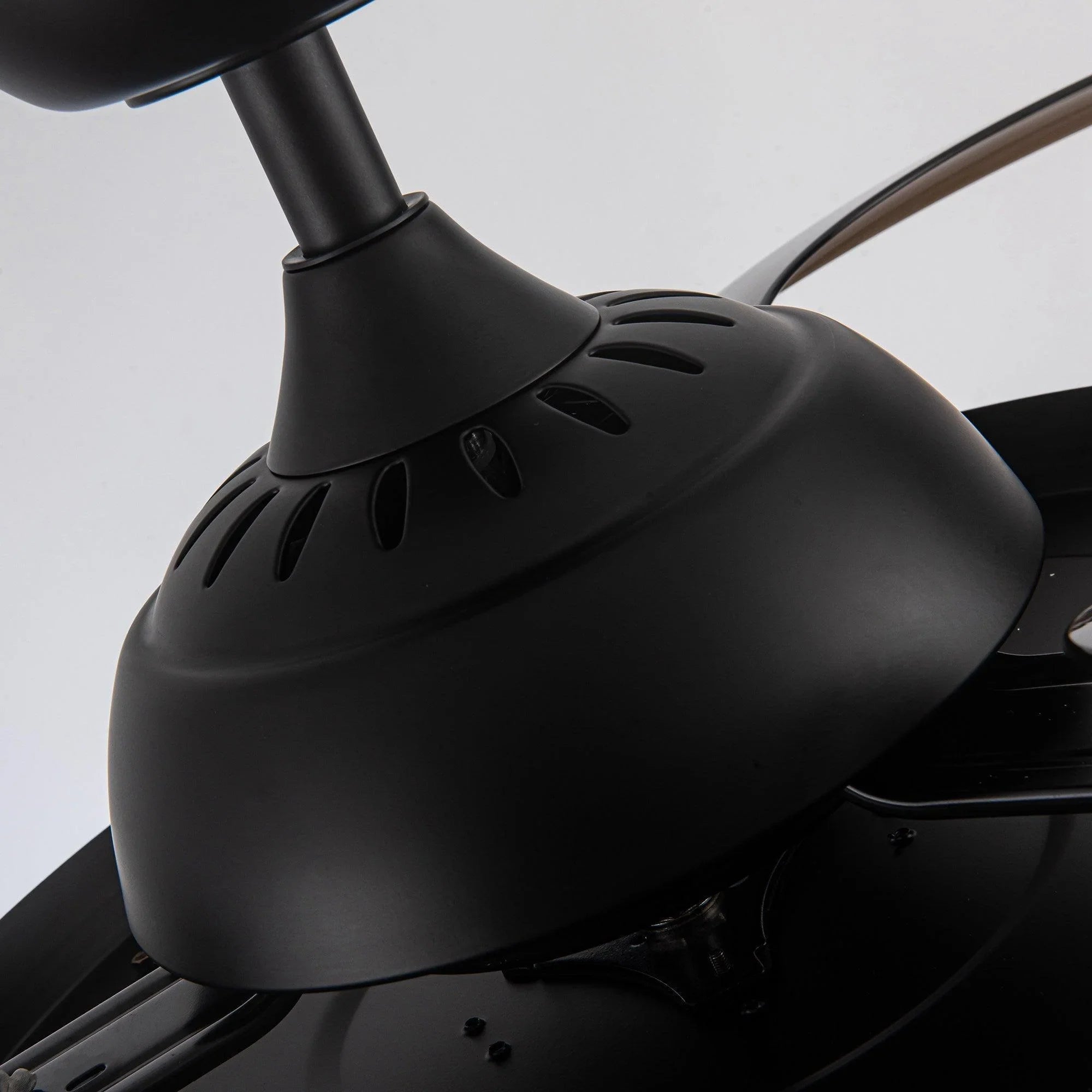 Black ceiling fan motor housing with streamlined blades and mounting bracket