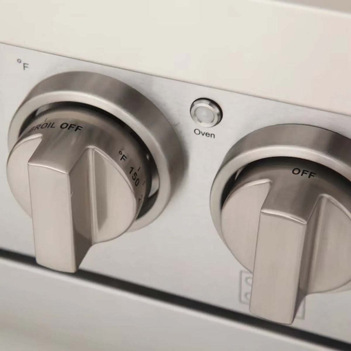 Light blue gas range control knobs on silver front panel