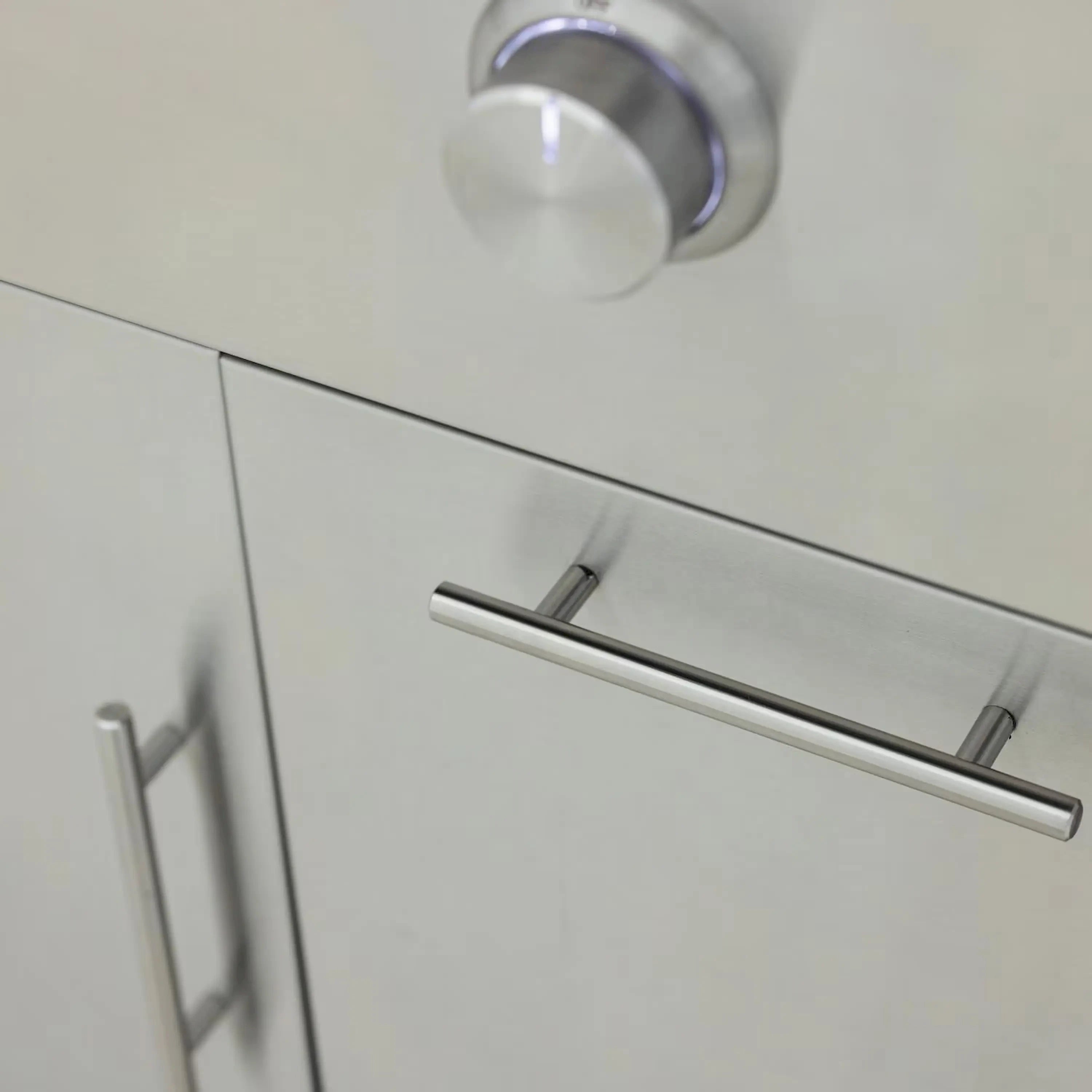 Stainless steel grill handle on freestanding griddle cabinet