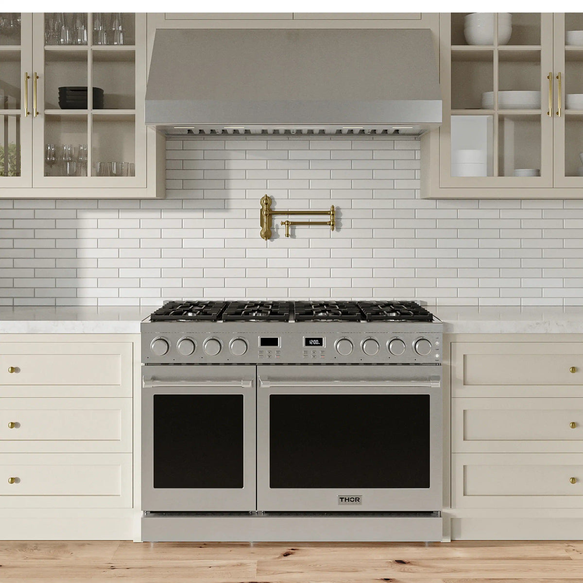 Stainless steel propane gas range in a kitchen with two black oven doors and gas burners