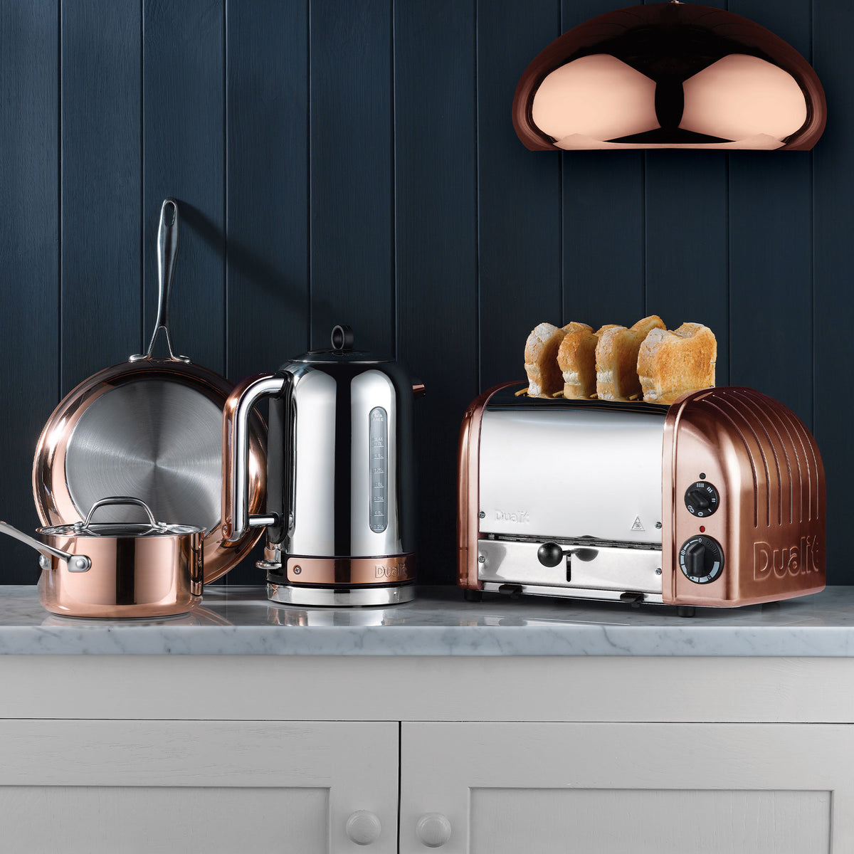 Copper and white Dualit 4-slice toaster with toast pieces on top