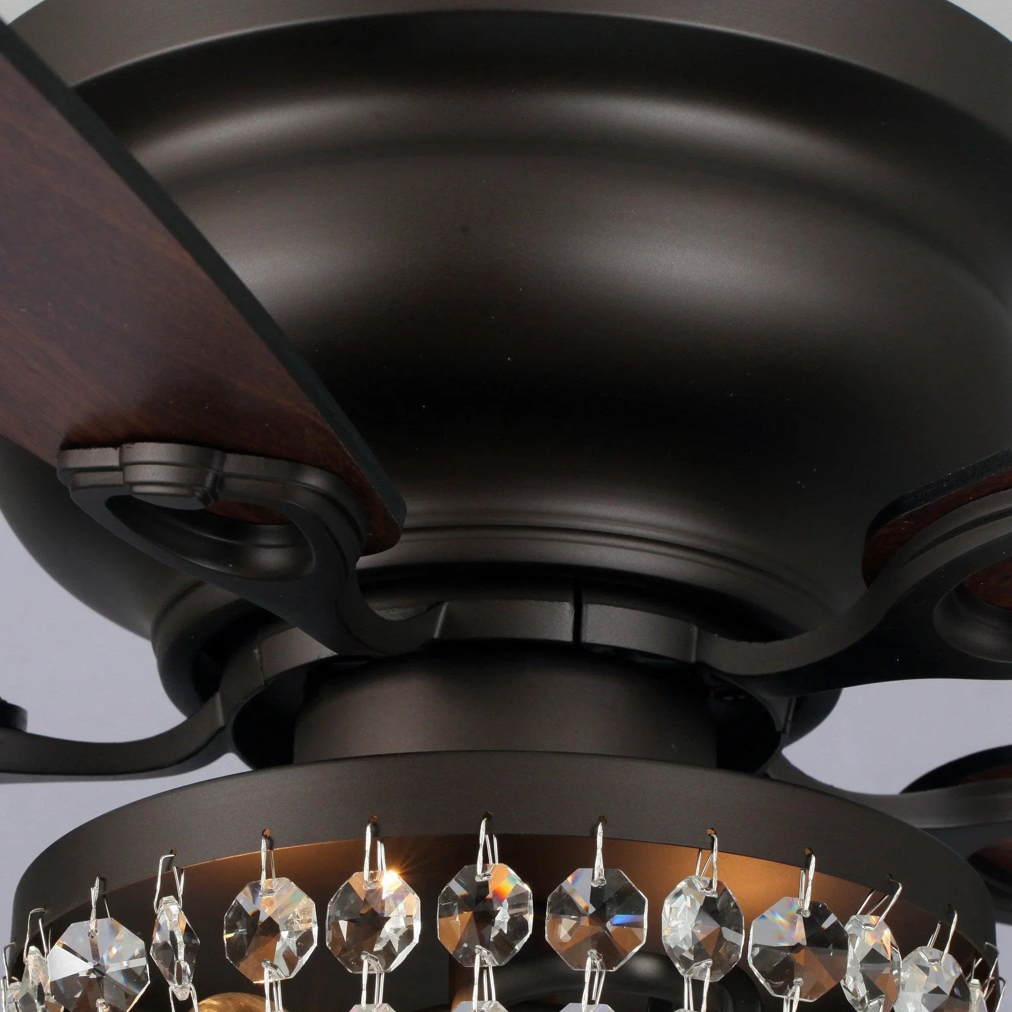 Flush mount ceiling fan underside with crystal light ring and lit bulb sockets