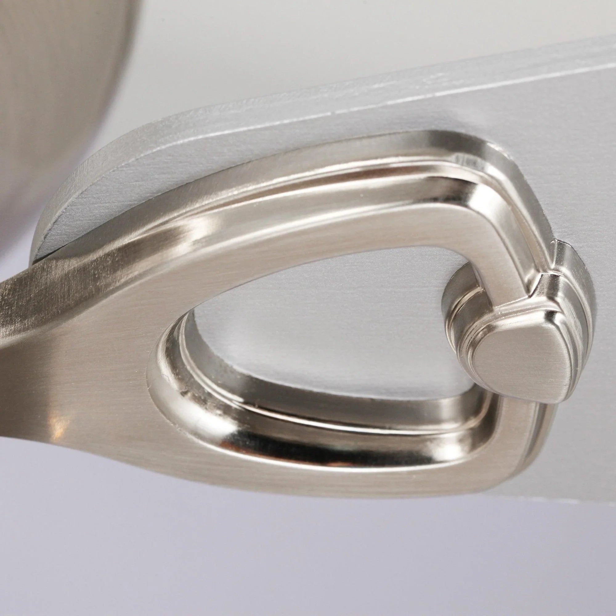 Close-up of brushed metal blade arm and motor housing on crystal flush mount fan