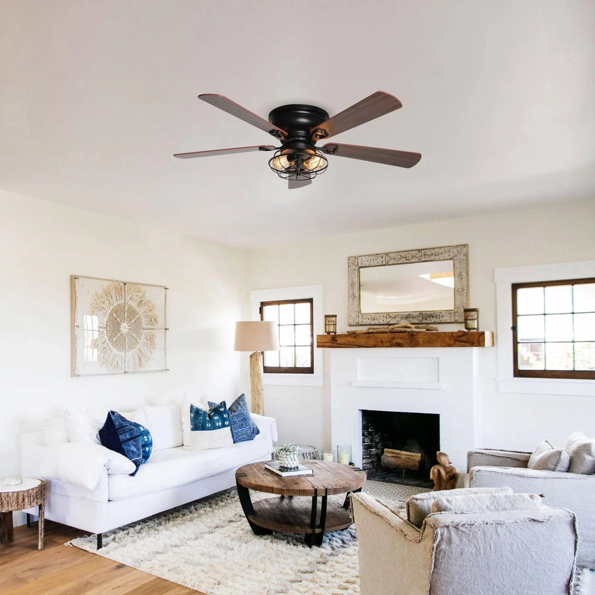 Black flush-mount ceiling fan with five dark wood blades and a caged light
