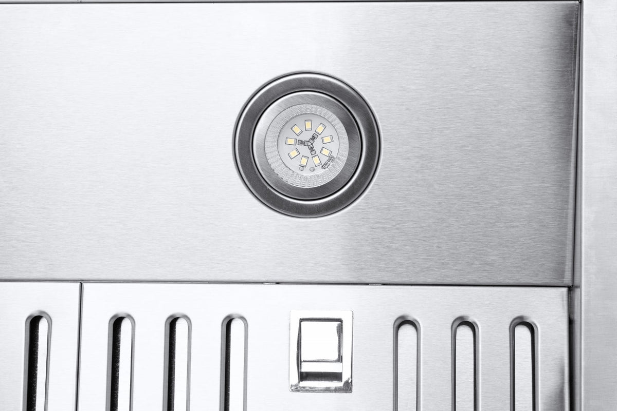 Circular light on stainless steel under-cabinet range hood with vented filter openings