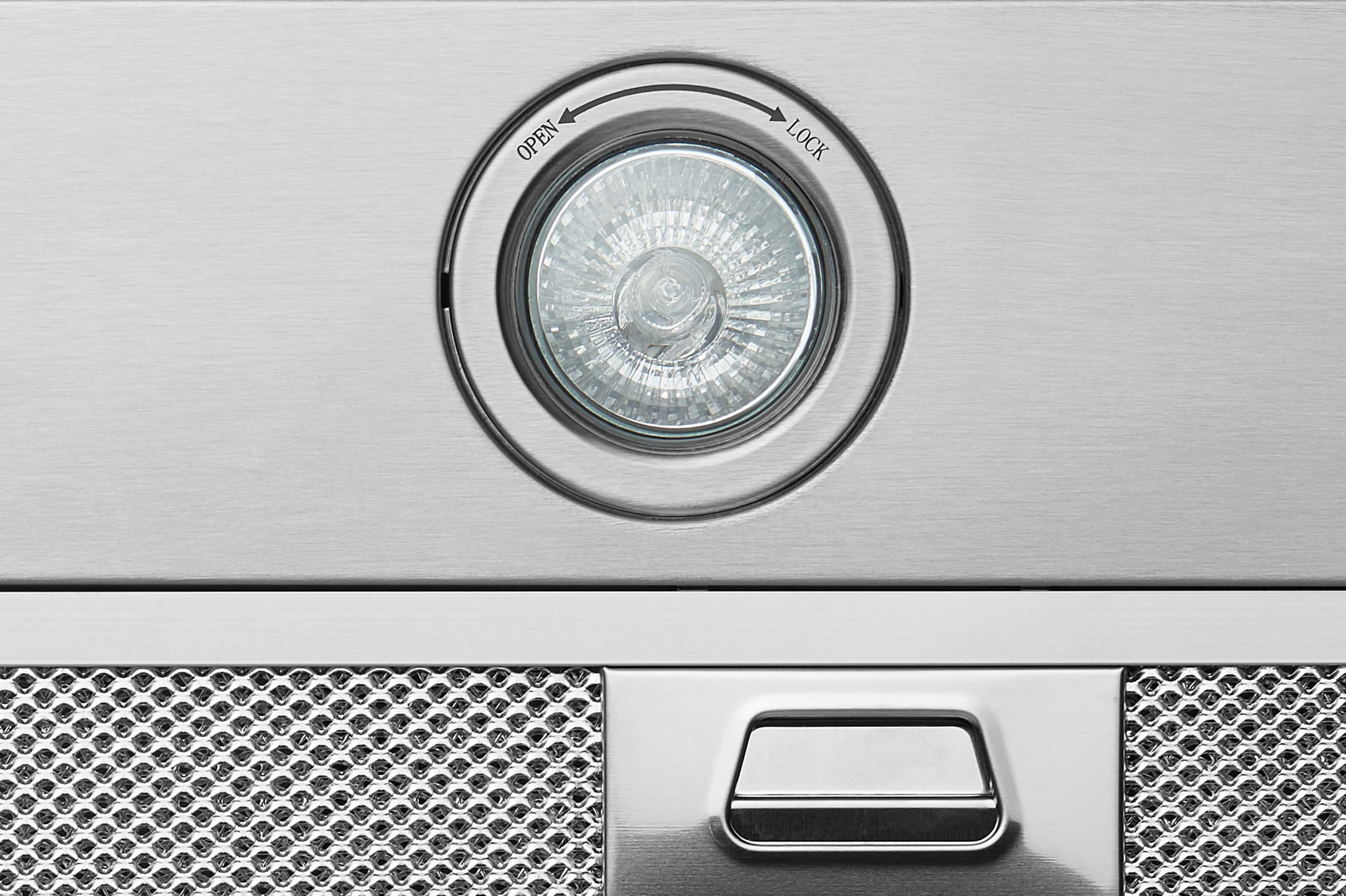 Stainless range hood fan opening with circular ring and open/lock markings.