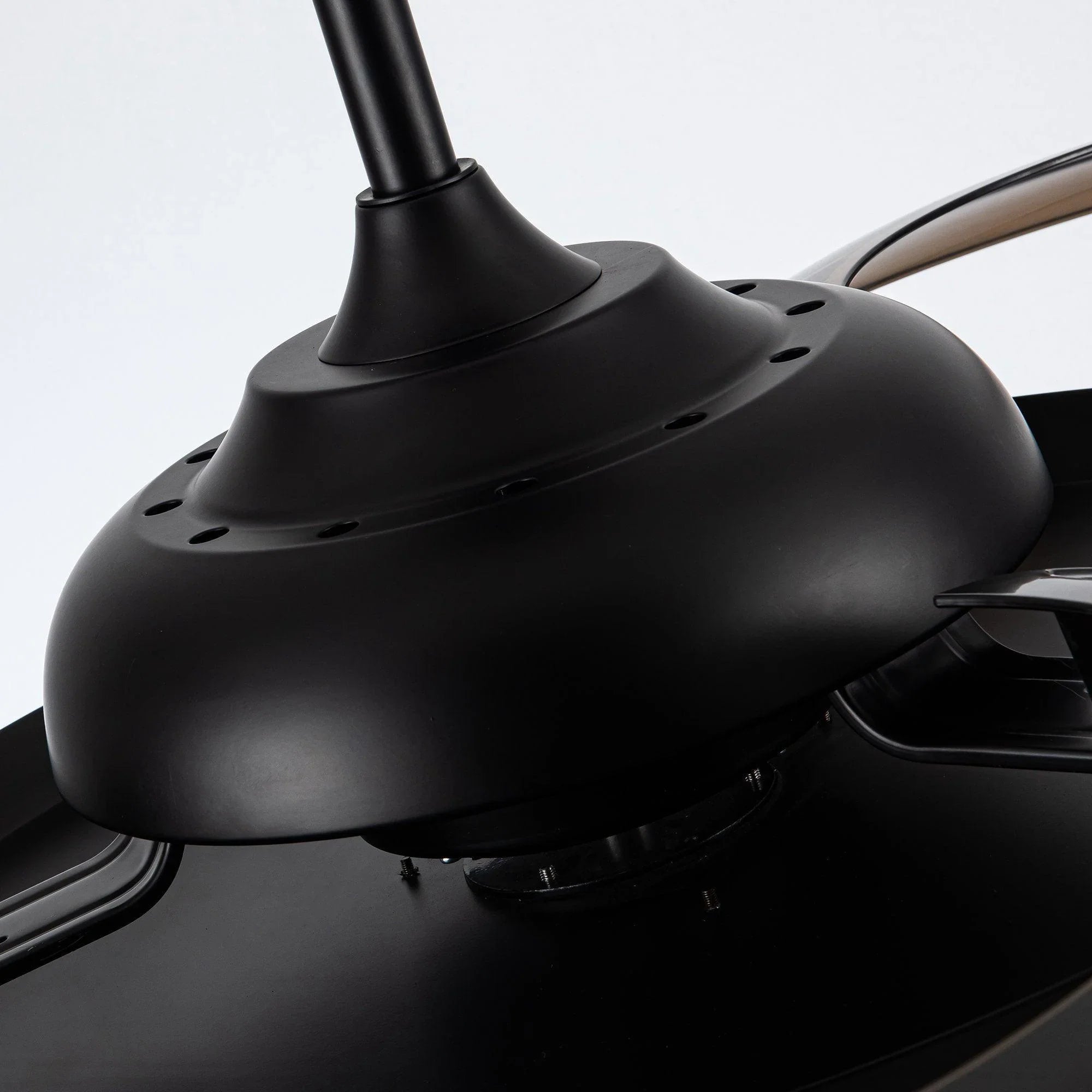 Black fan motor housing with center stem, close-up view of ceiling fan