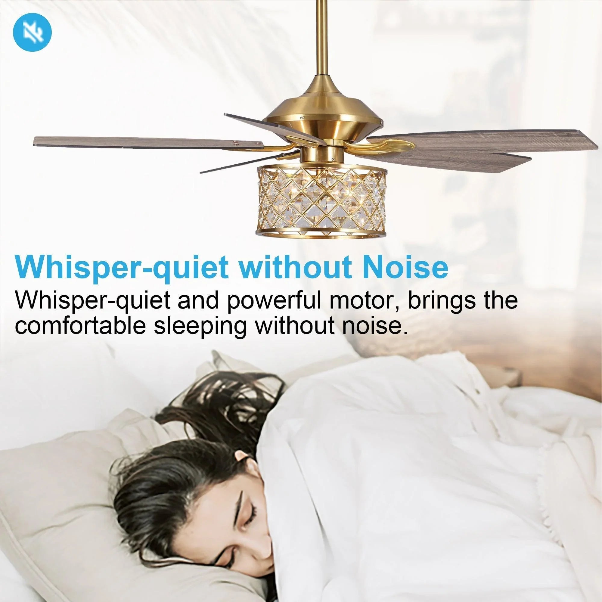 Golden ceiling fan with crystal light fixture and reversible dark wood blades over bed