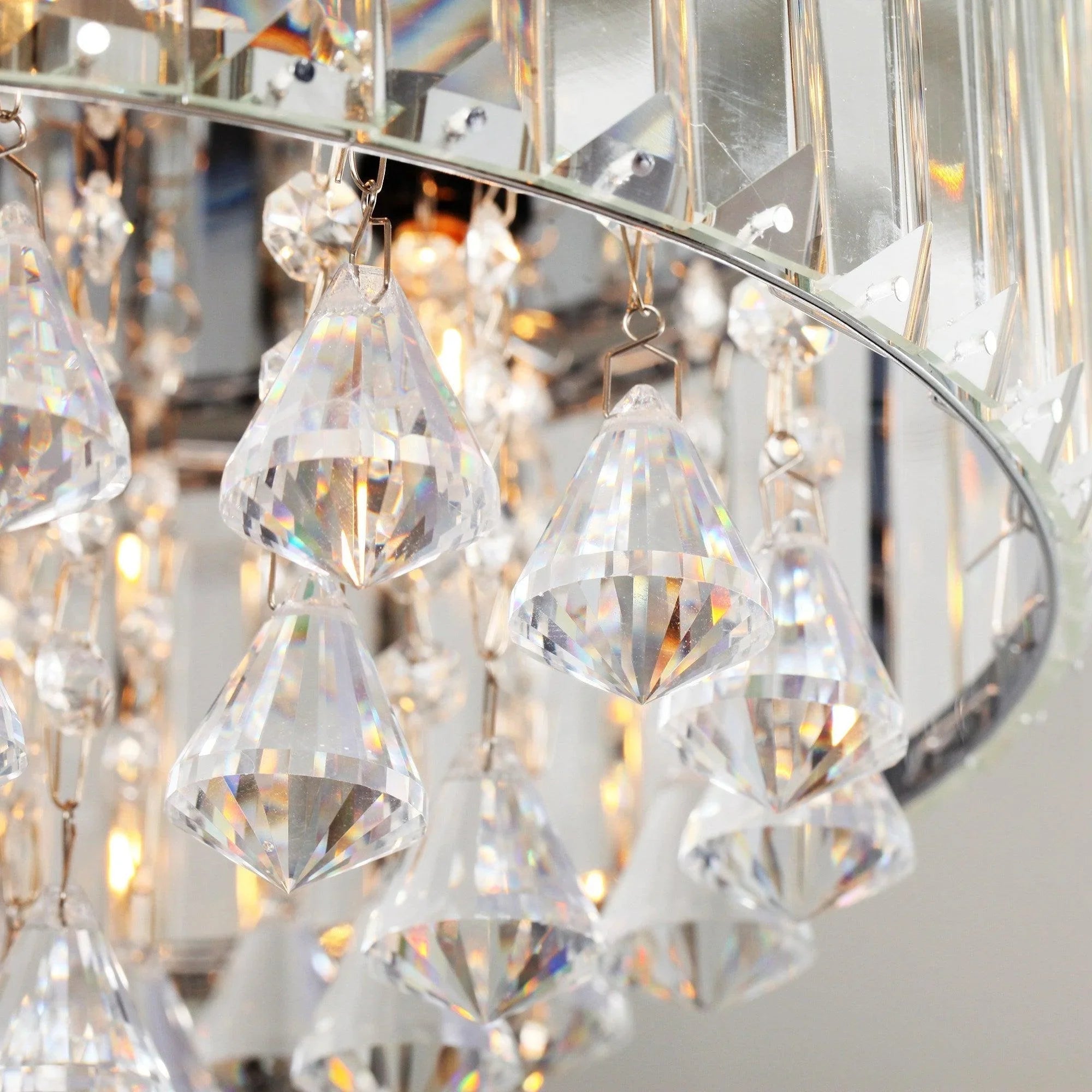 Clear crystal drops on a chrome fandelier housing, with faceted prism details.