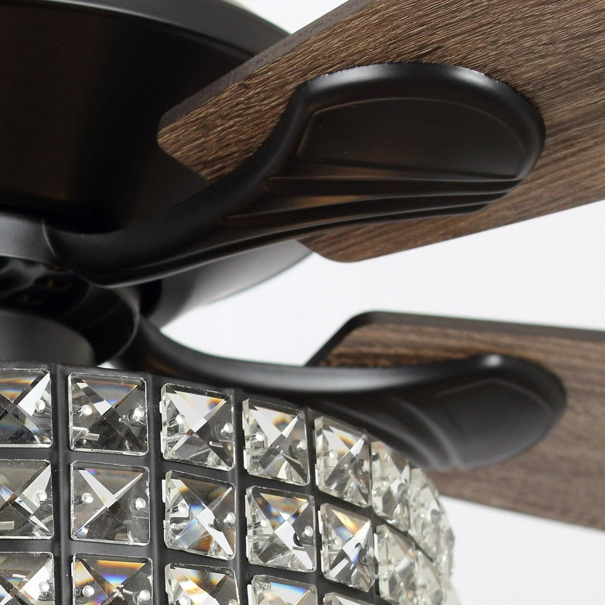 Close-up of black ceiling fan blades and crystal light housing