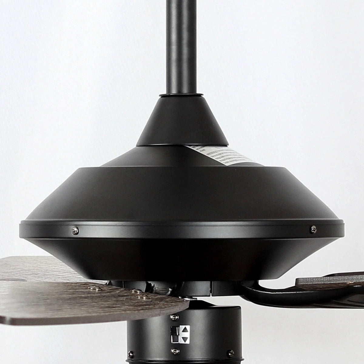 Black fan canopy and downrod with wood blade near crystal light drum