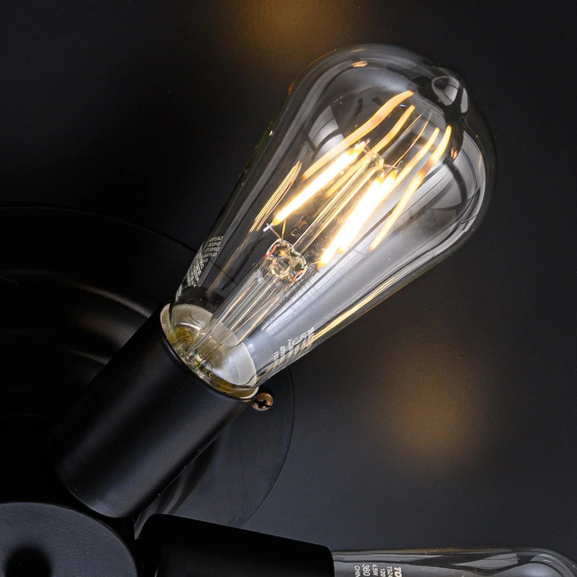 Black industrial ceiling fan light with clear glass bulb cover and exposed filaments
