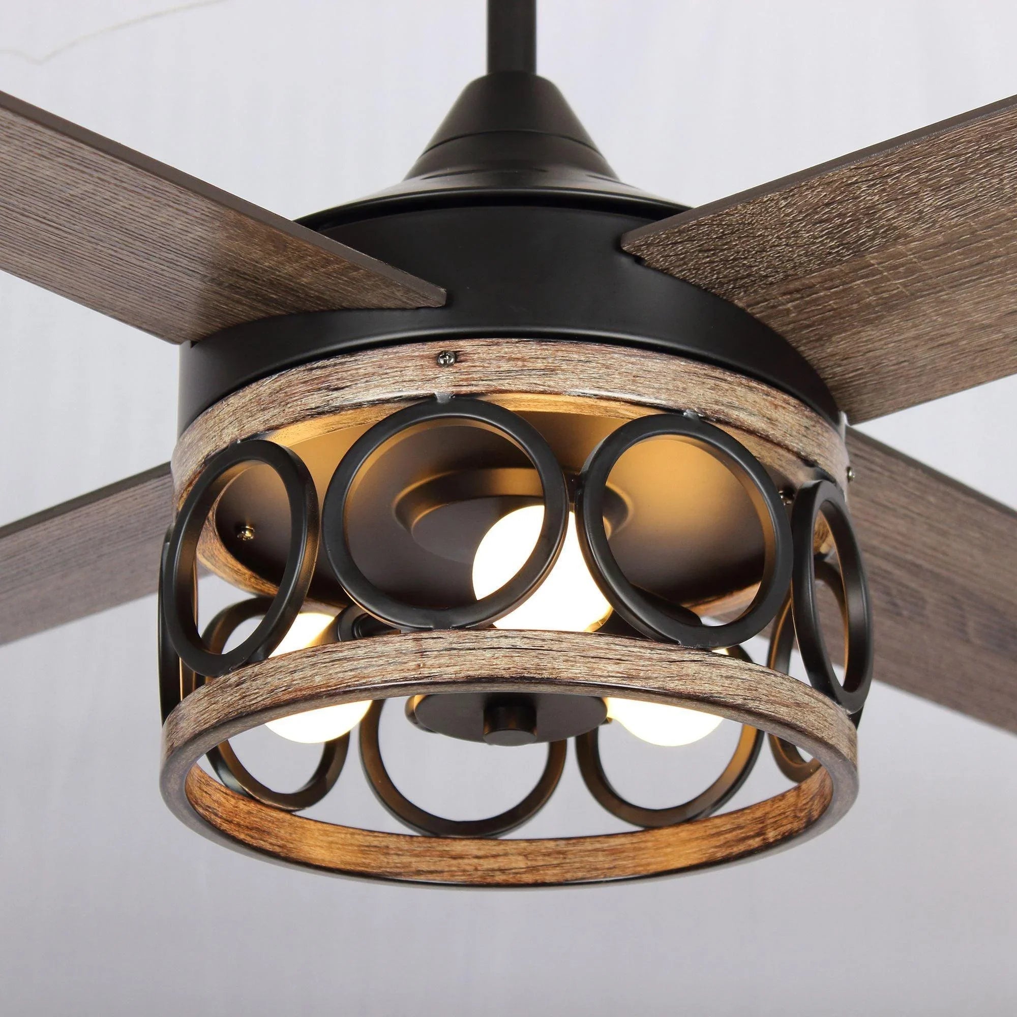 Close-up of black ceiling fan lantern light with circular metal ring design.
