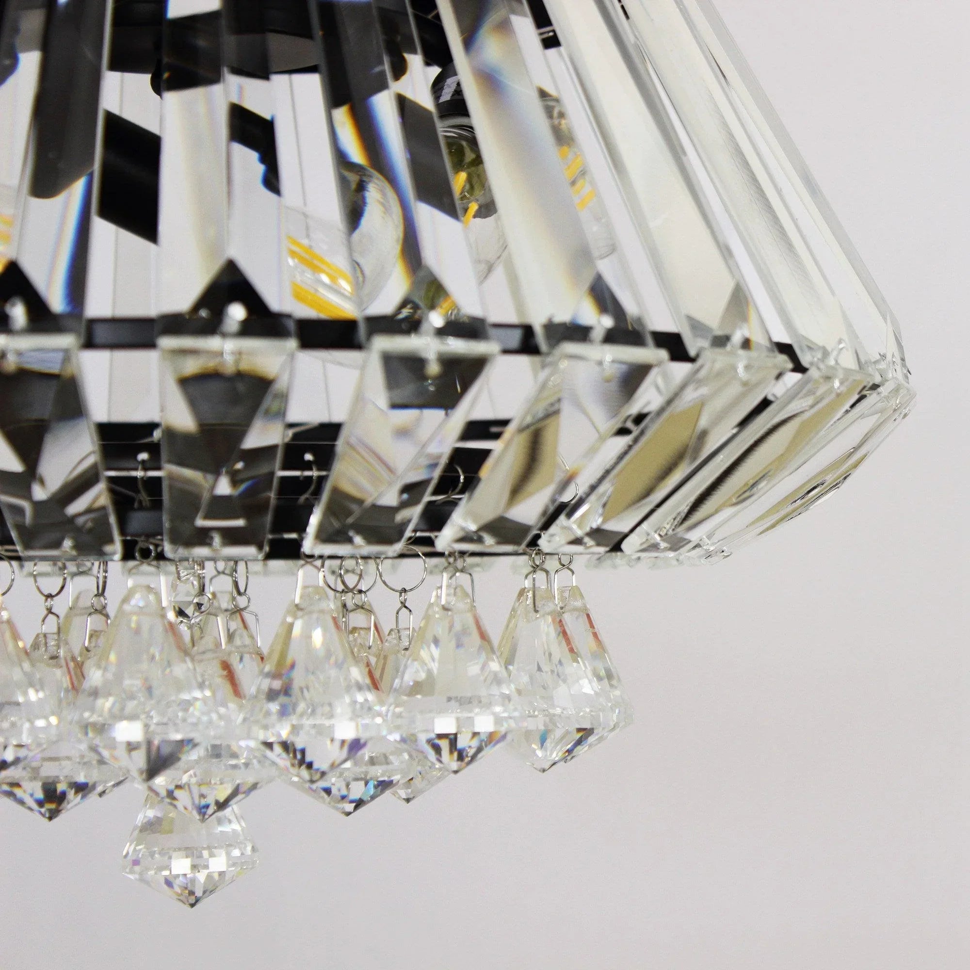 Clear crystal light cluster with faceted prisms beneath ceiling fan