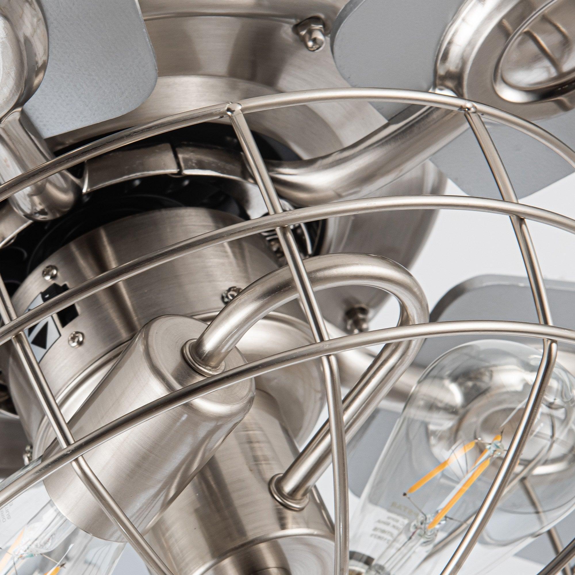 Brushed nickel interior of caged ceiling fan showing wiring and glass bulb sockets