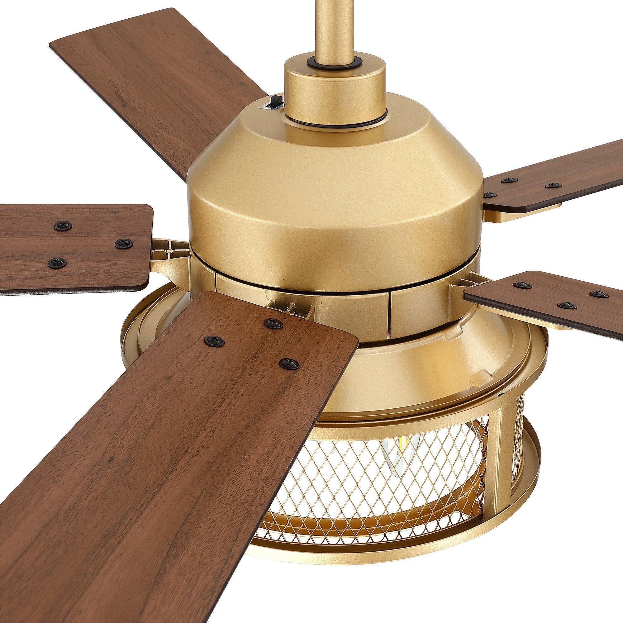 Close-up of gold ceiling fan motor with five brown blades and caged light