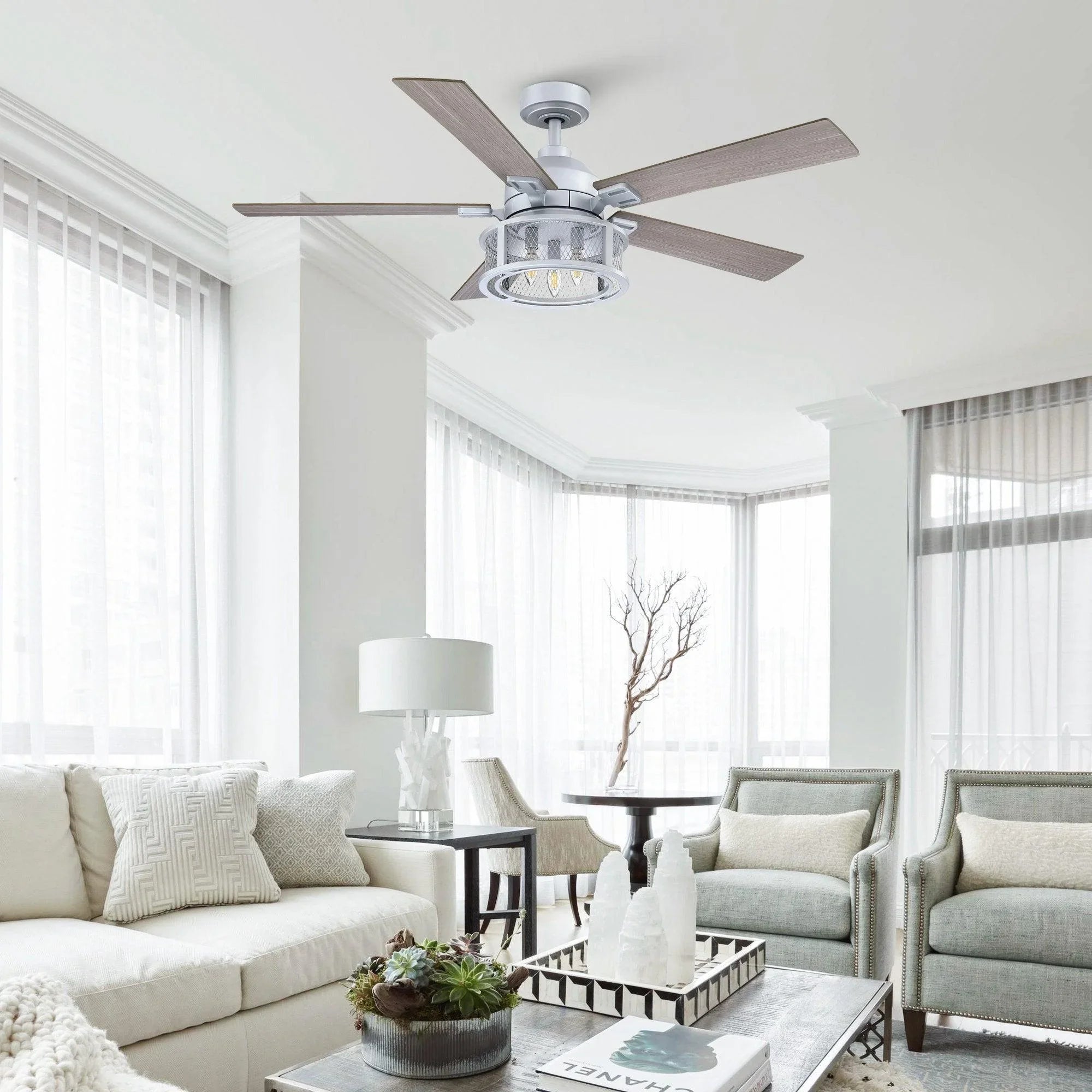 Silver ceiling fan with five blades and integrated light in a living room
