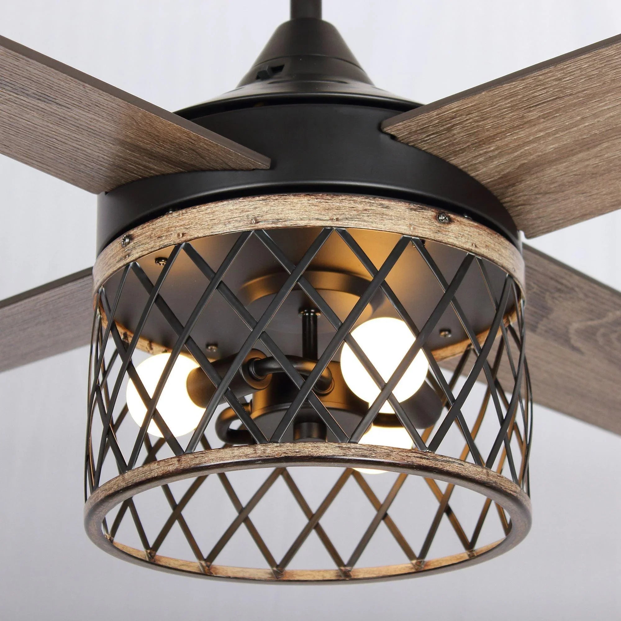 Black ceiling fan light fixture with diamond-pattern metal cage surround.