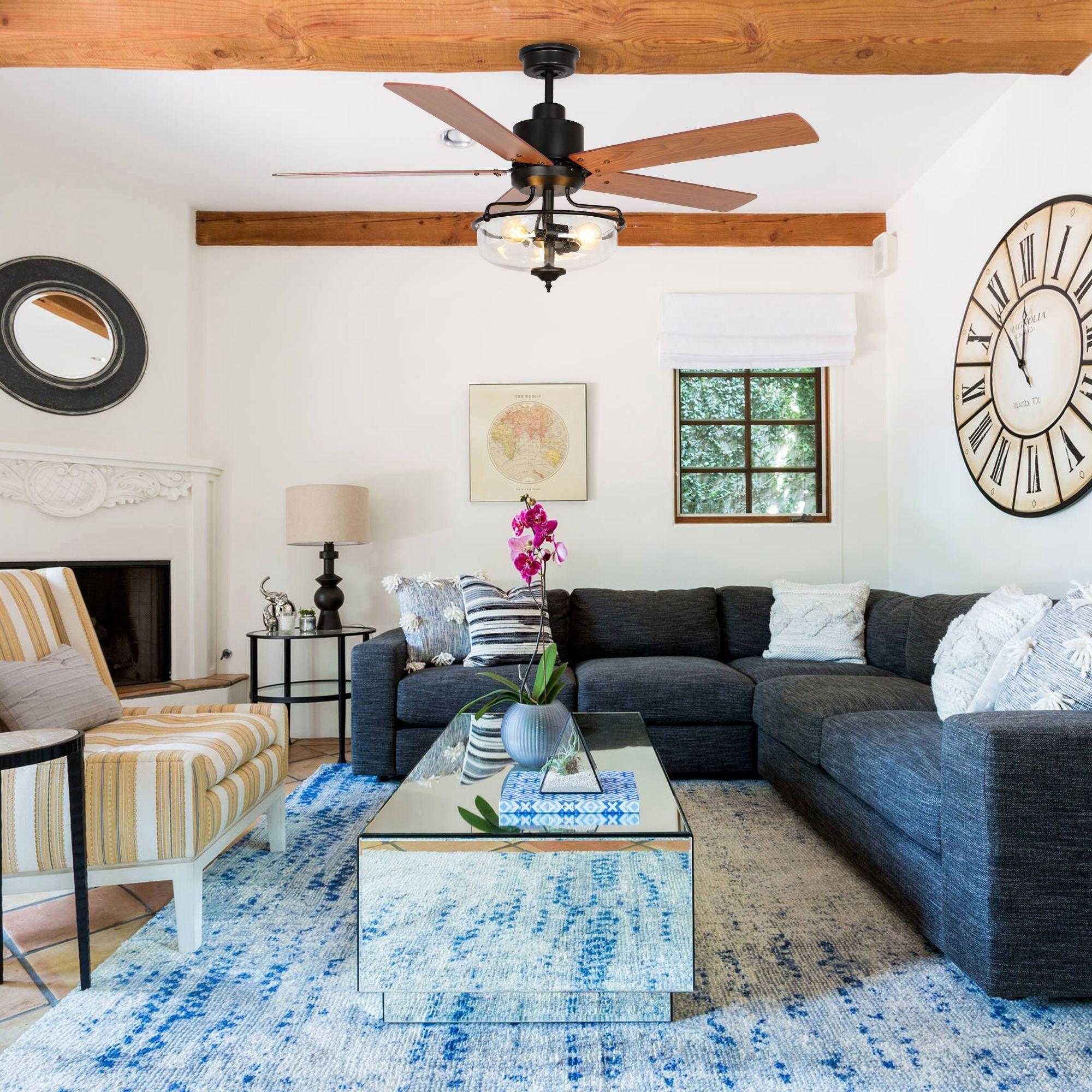 Industrial black ceiling fan with light and wooden reversible blades, mounted on downrod