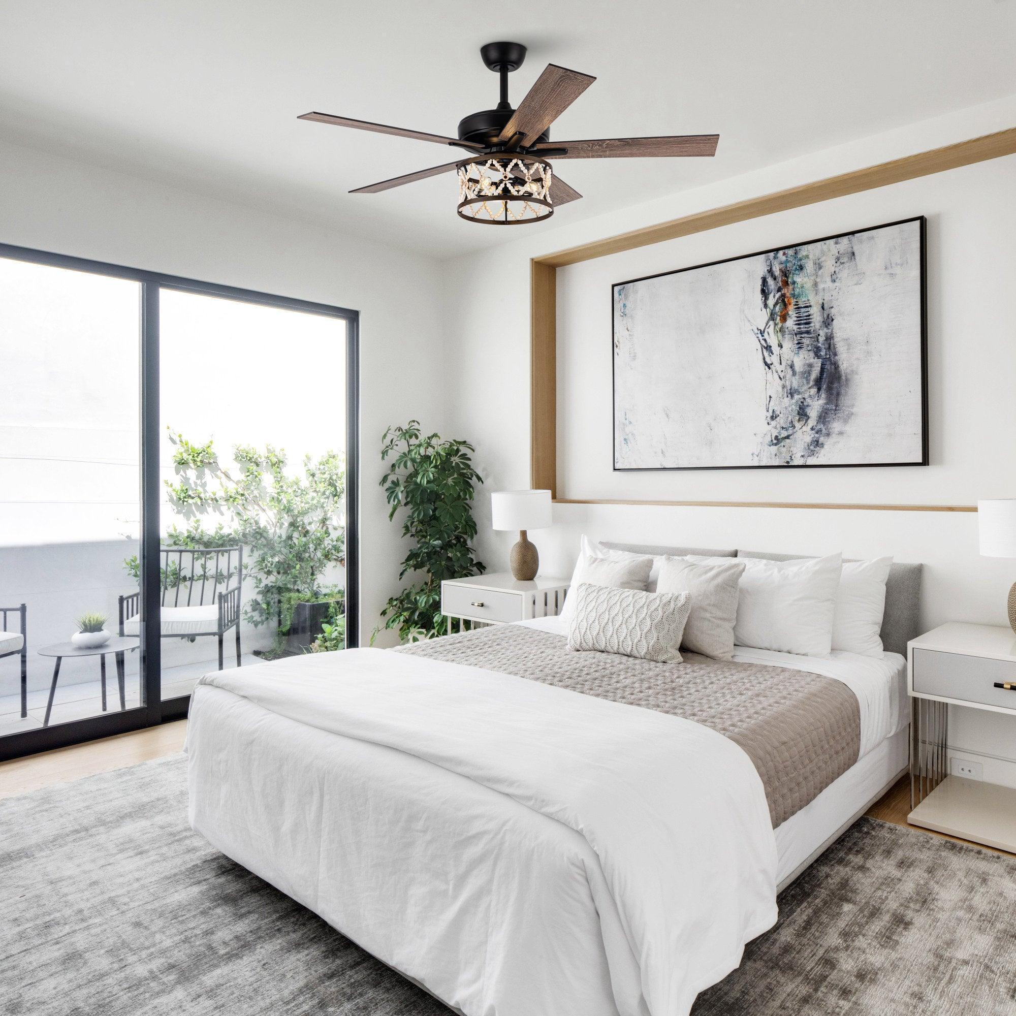 Ceiling fan with black housing, wood-toned reversible blades, and lit light fixture