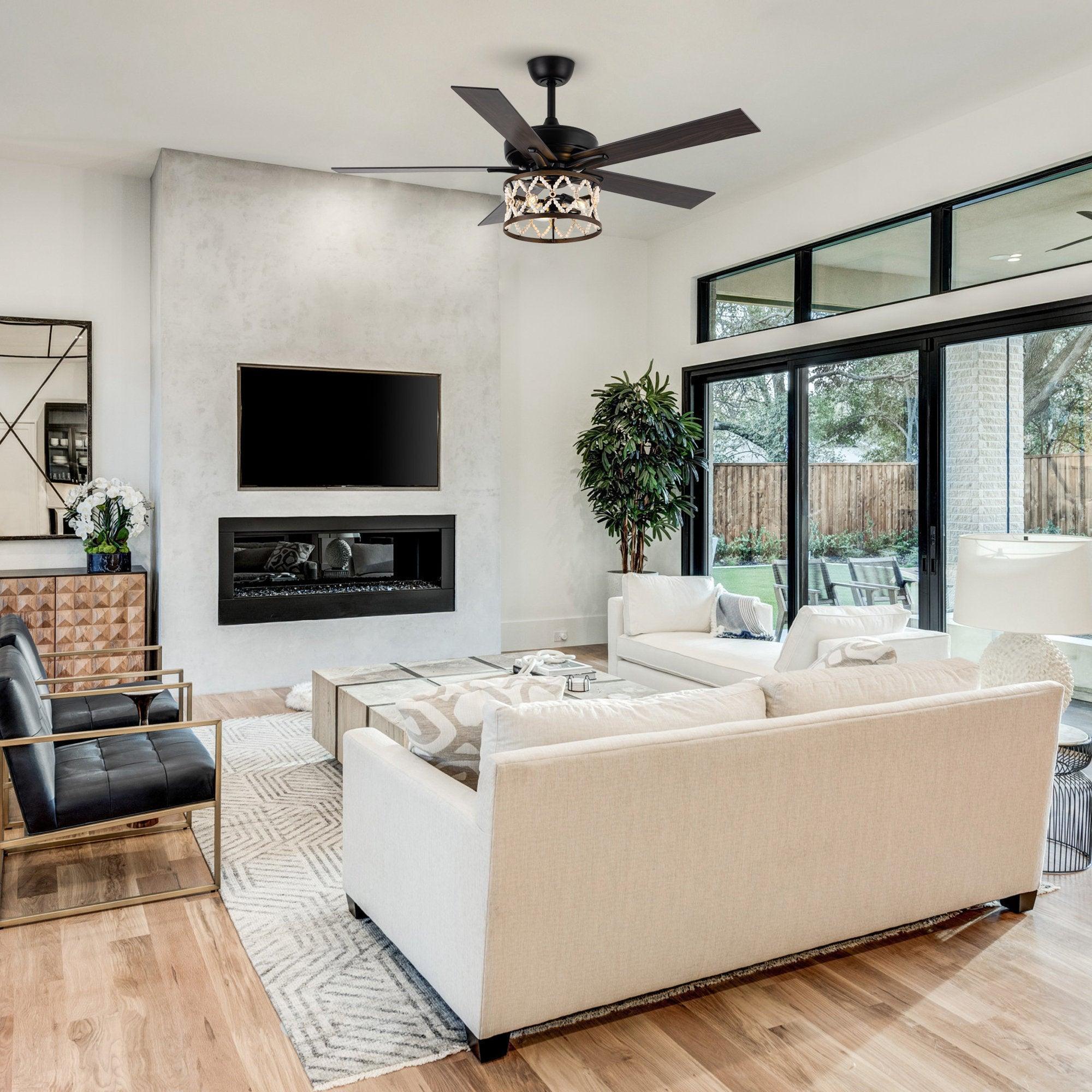 Ceiling fan installed on ceiling with black housing, wood-toned blades, and lit light fixture