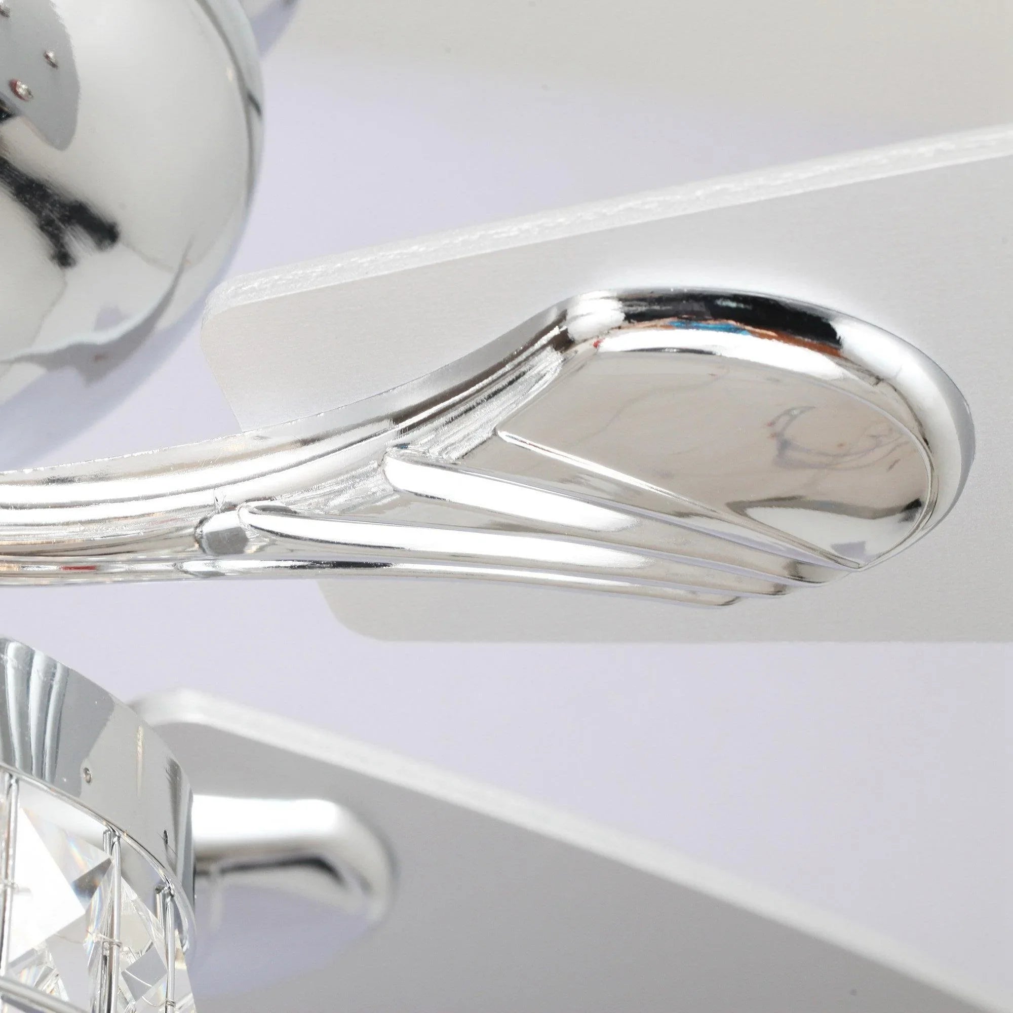 Chrome ceiling fan blade and motor housing detail with crystal light kit