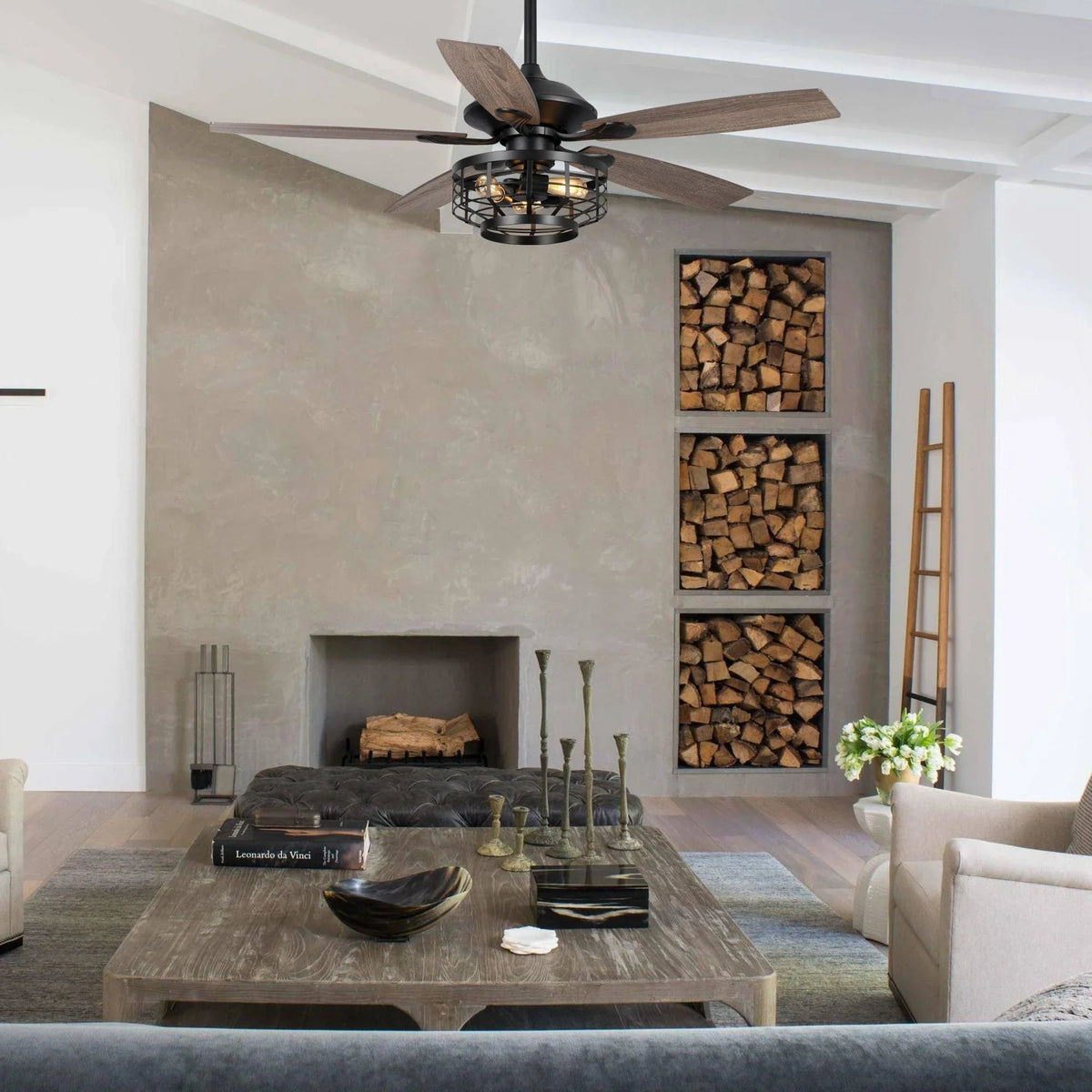Black industrial ceiling fan with wood-toned reversible blades and caged light housing