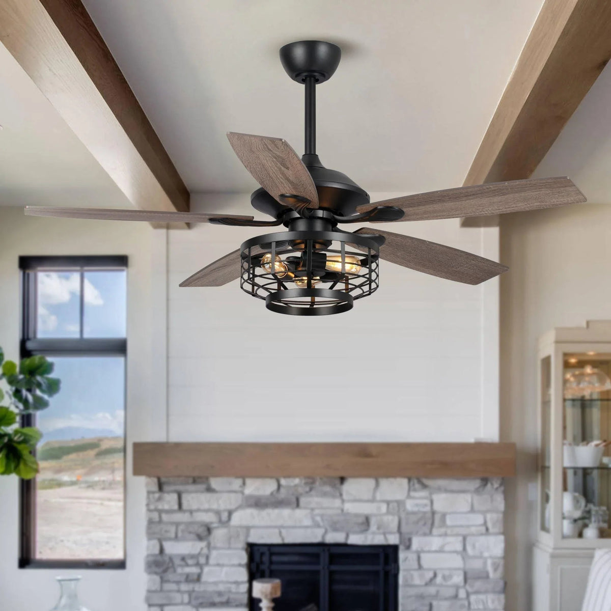 Black ceiling fan with wood-toned blades and caged light, flush-mounted on ceiling