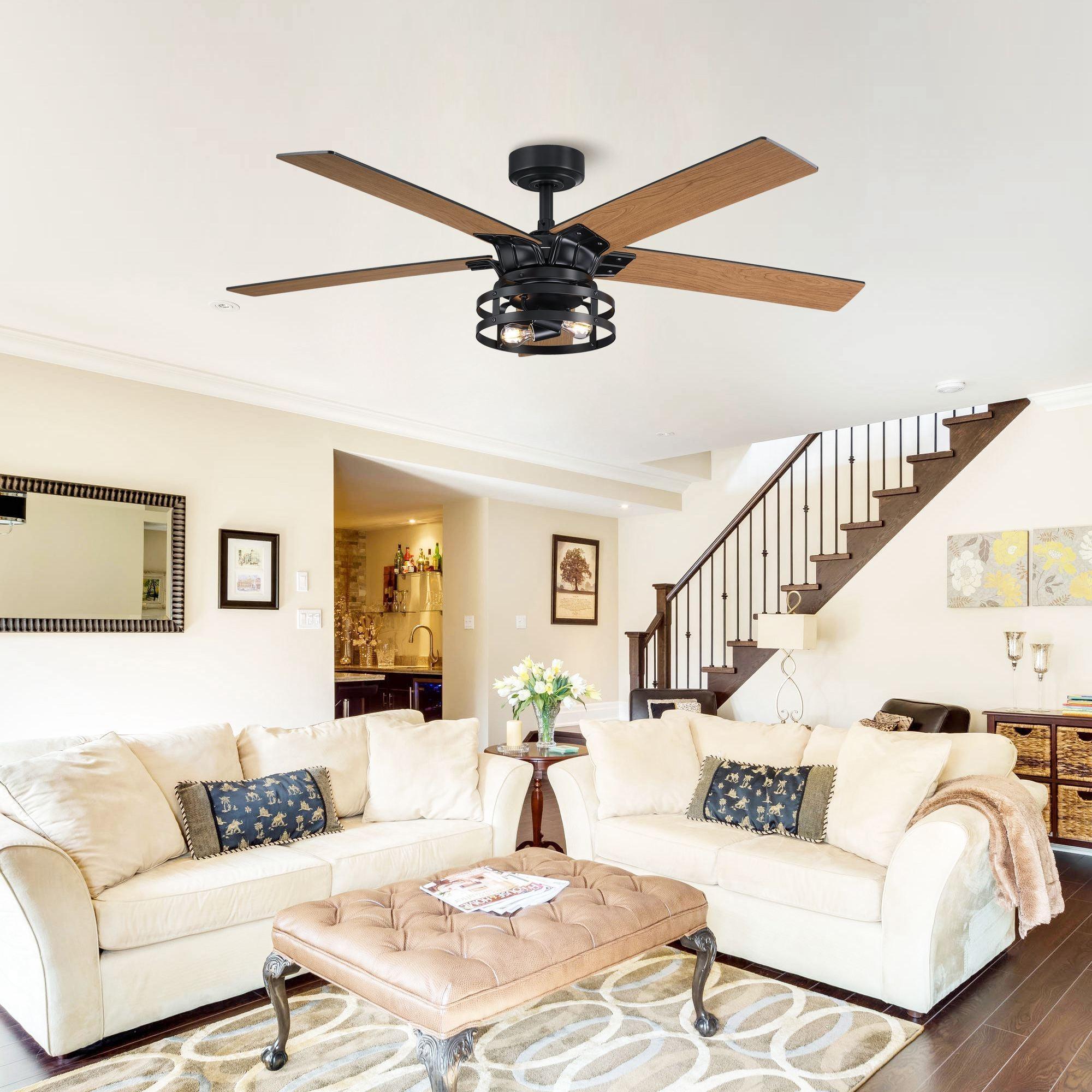 Black ceiling fan with wood blades and caged light, mounted on ceiling