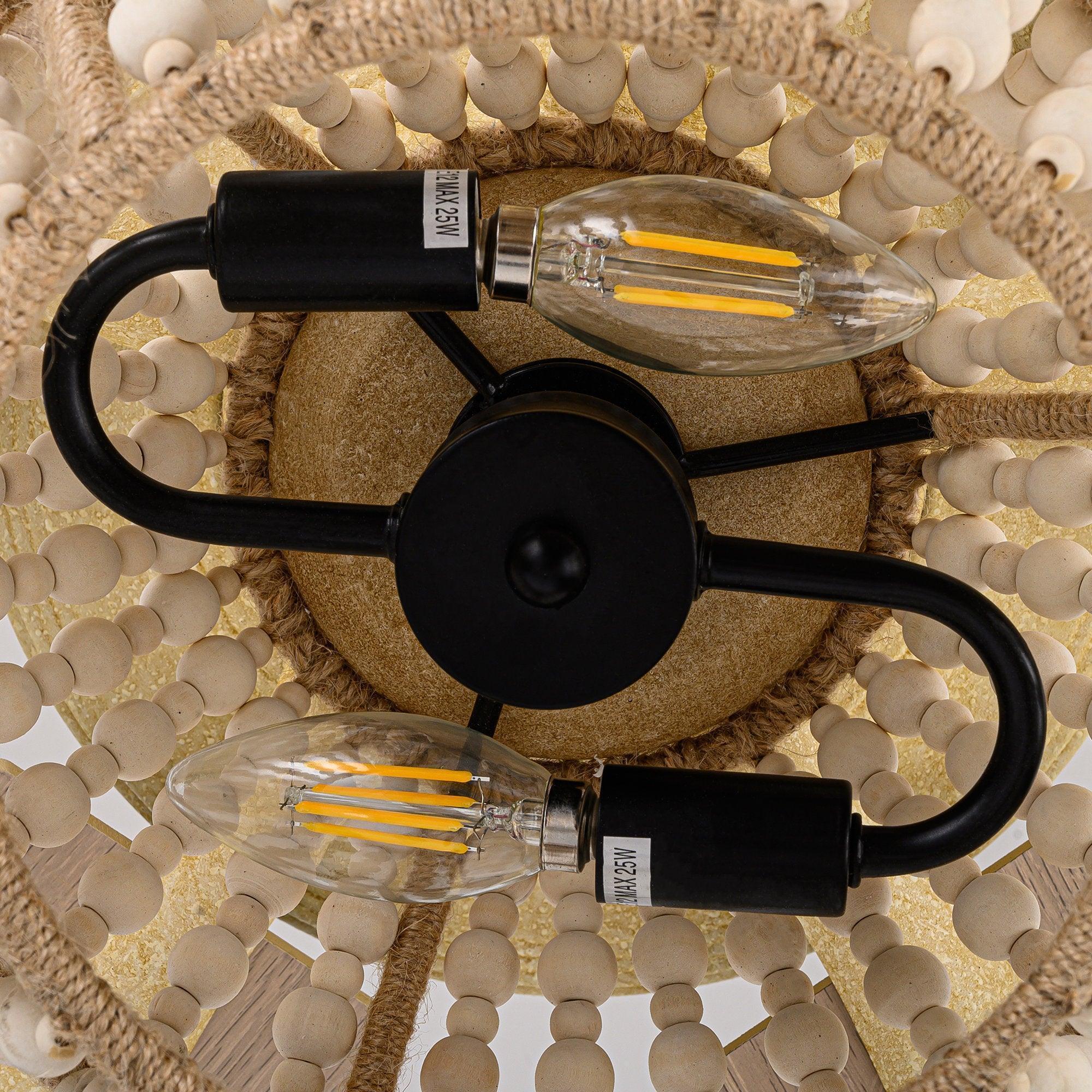 Close-up of globe light sockets with clear bulbs inside the beaded cage