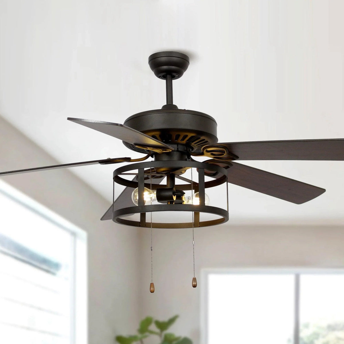 Black ceiling fan with lantern light housing and exposed bulbs, hanging pull chains