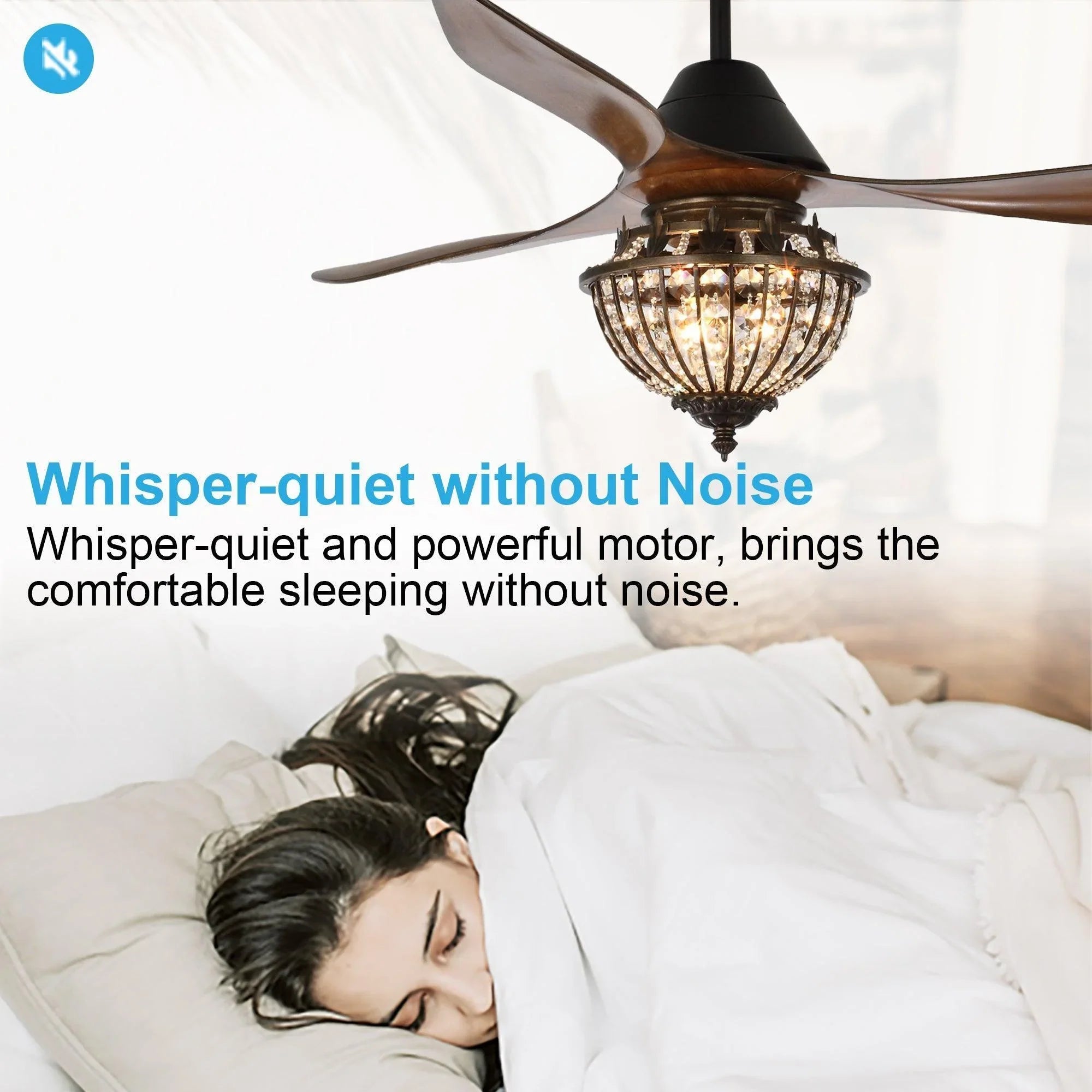 Black ceiling fan with crystal glass light above a person resting on a bed