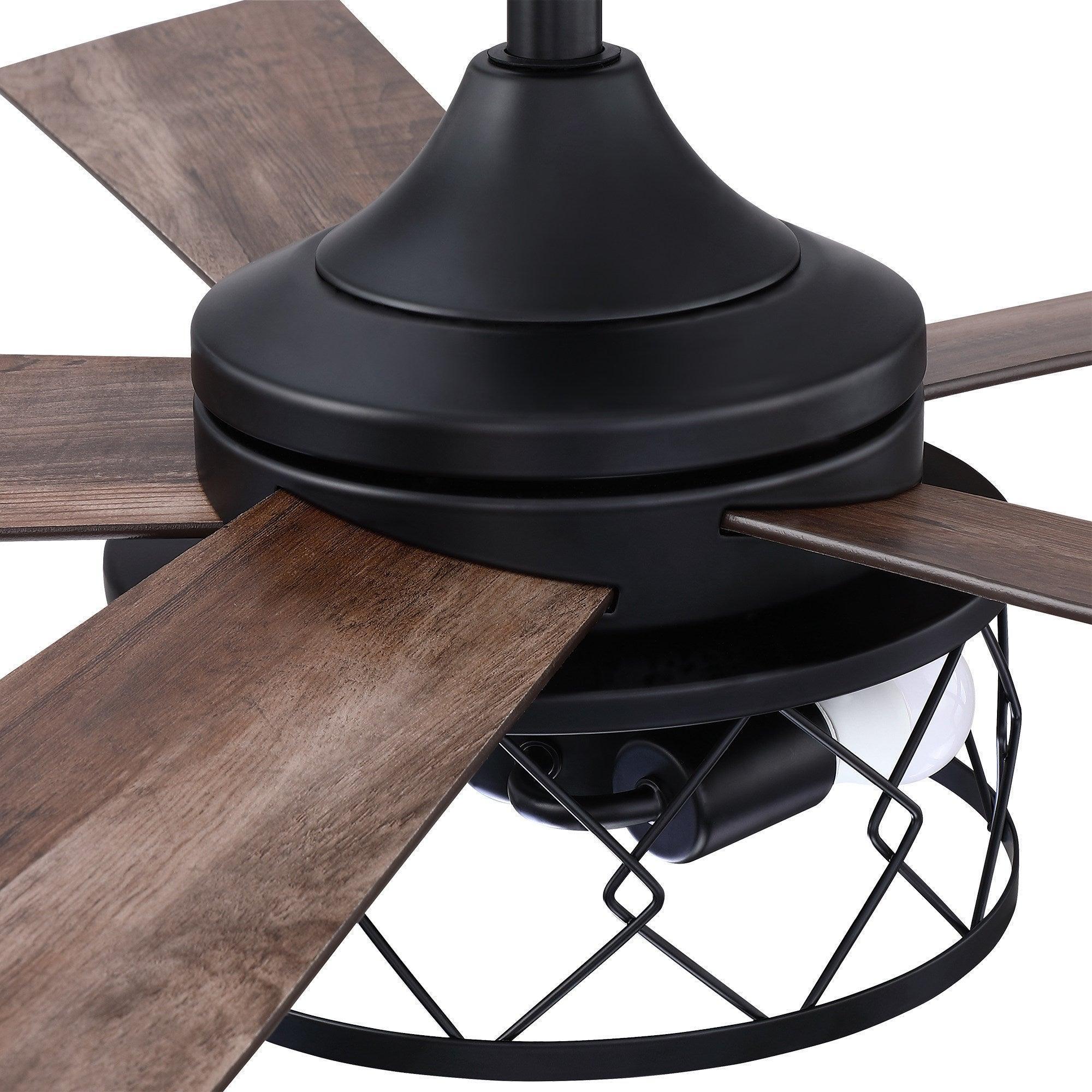 Black ceiling fan motor housing with lantern light cage and reversible blade tips