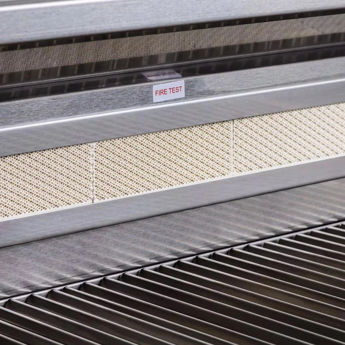 Stainless steel gas grill fire test label above front vent