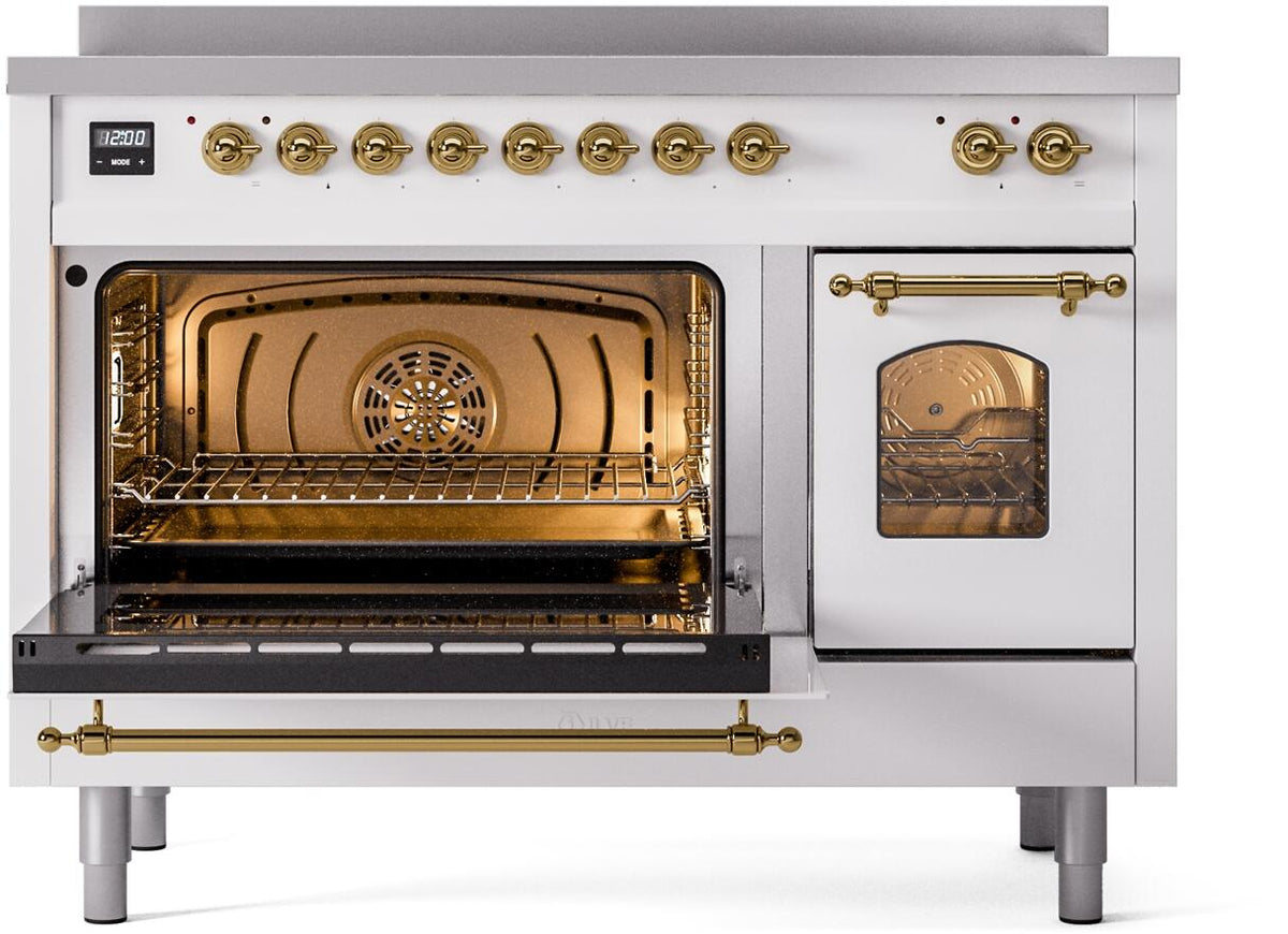 White range with brass controls; oven door open showing lit interior and racks