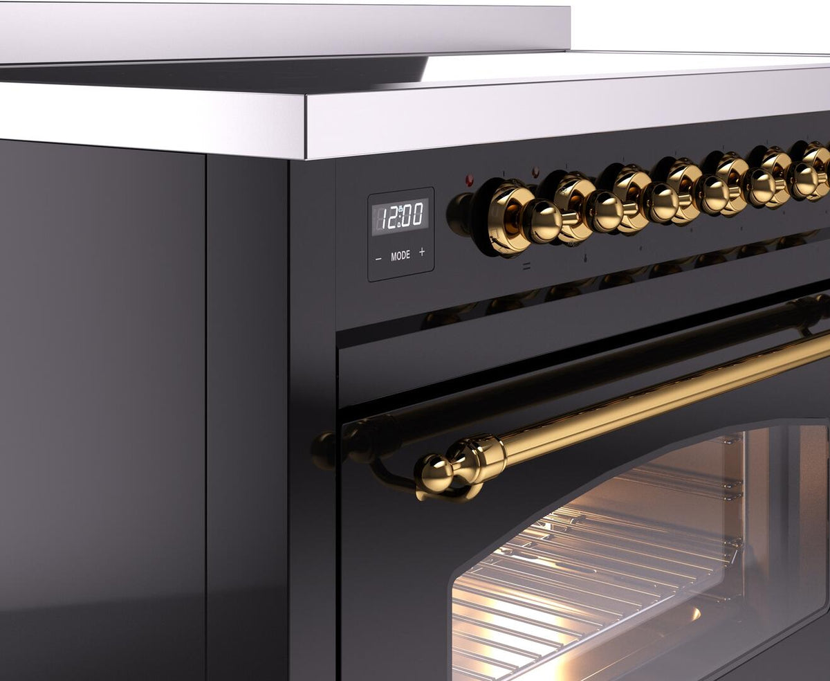 Freestanding electric induction range control panel with brass knobs and digital display
