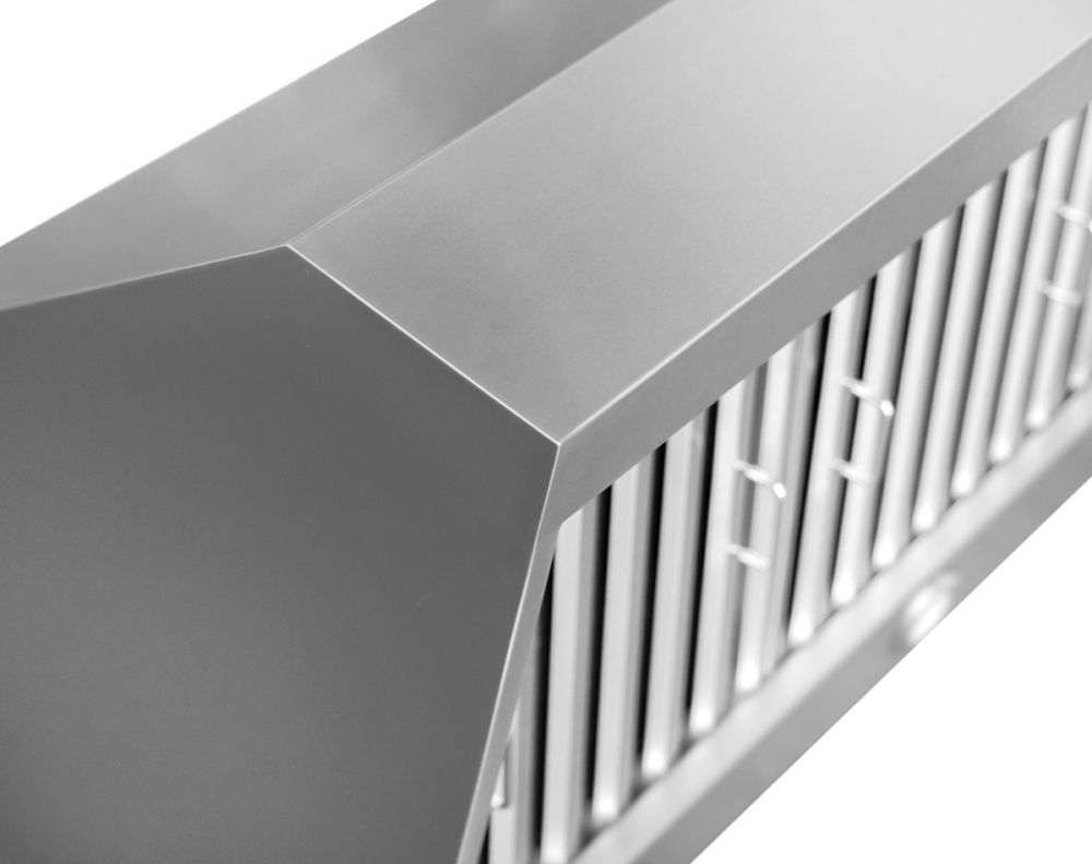 Stainless steel chimney hood corner with vent filter grille, close-up