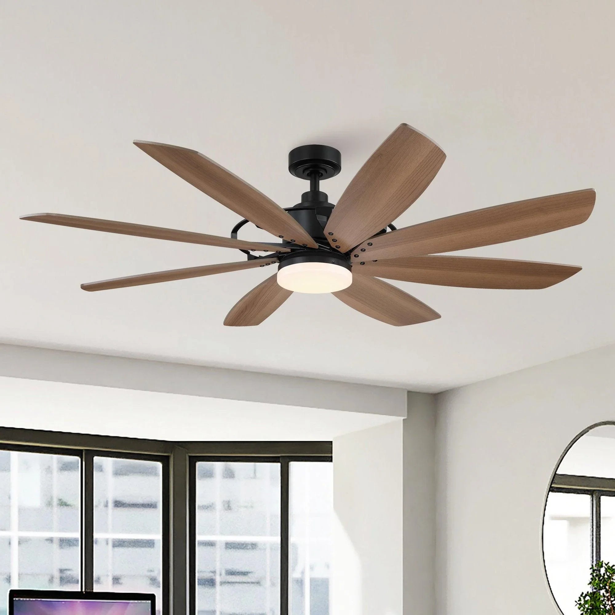 Ceiling fan with black motor housing, wood blades, and a white integrated light fixture.