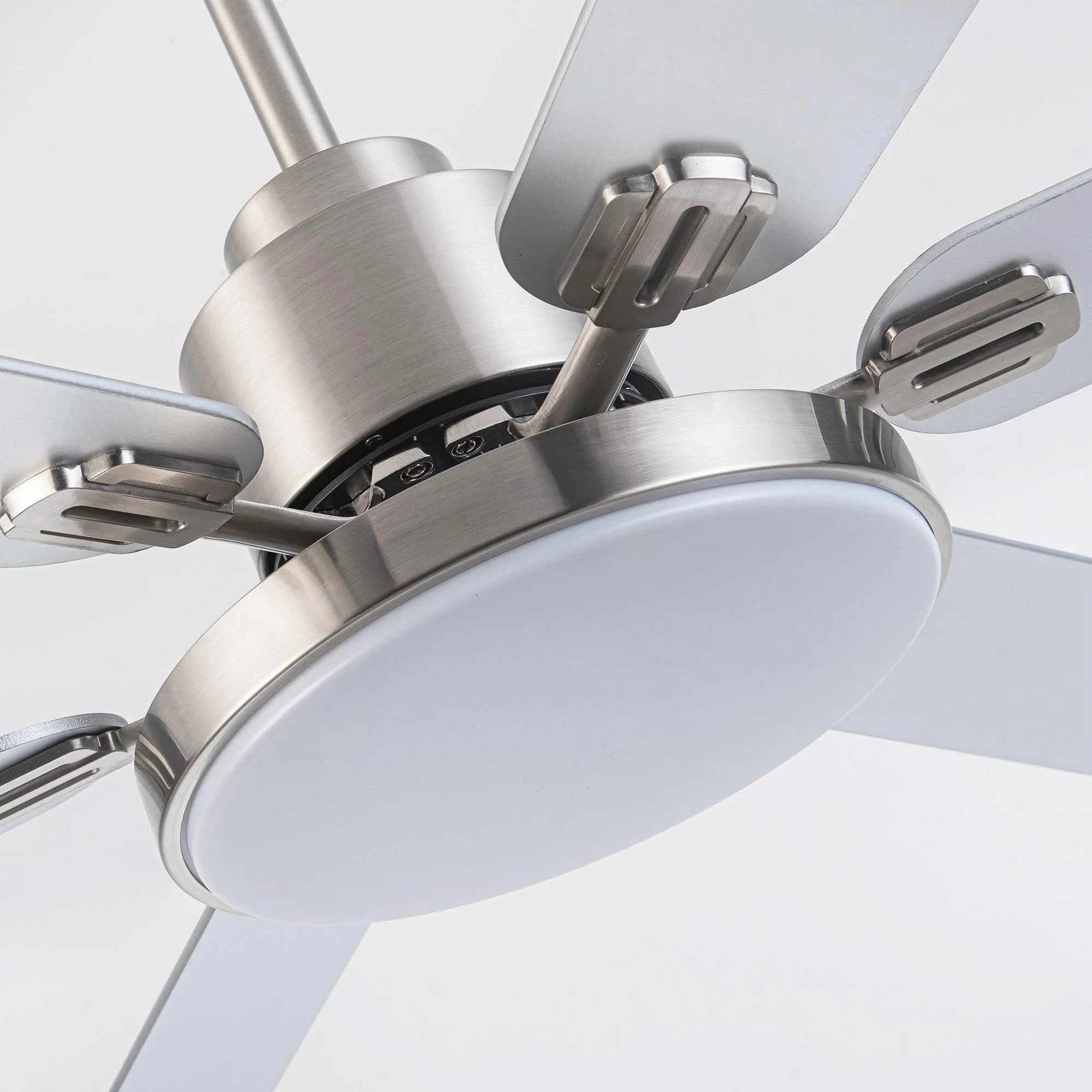 Satin nickel ceiling fan motor housing with white light plate and blade arms