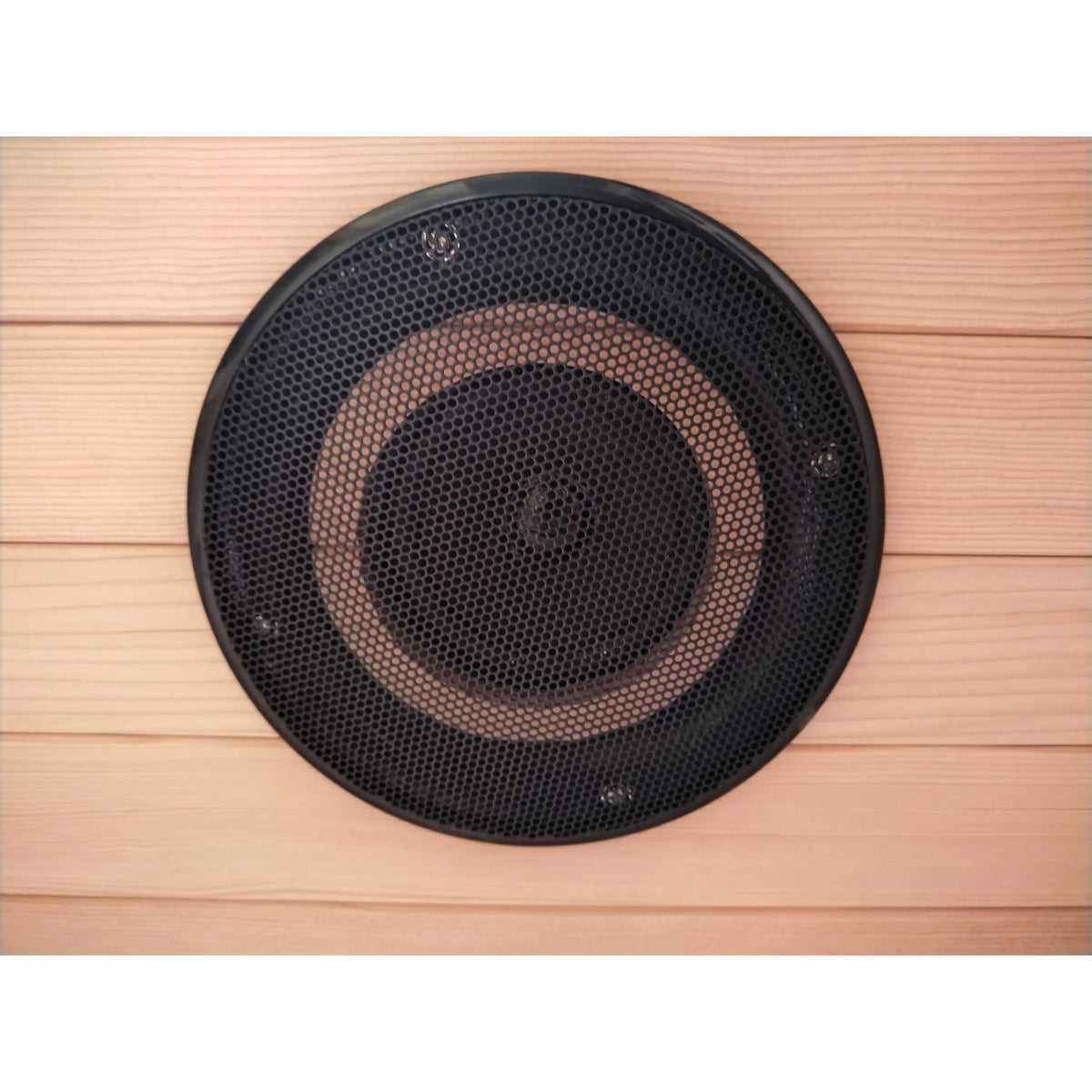 Infrared sauna heater speaker-style grille mounted on light wood wall