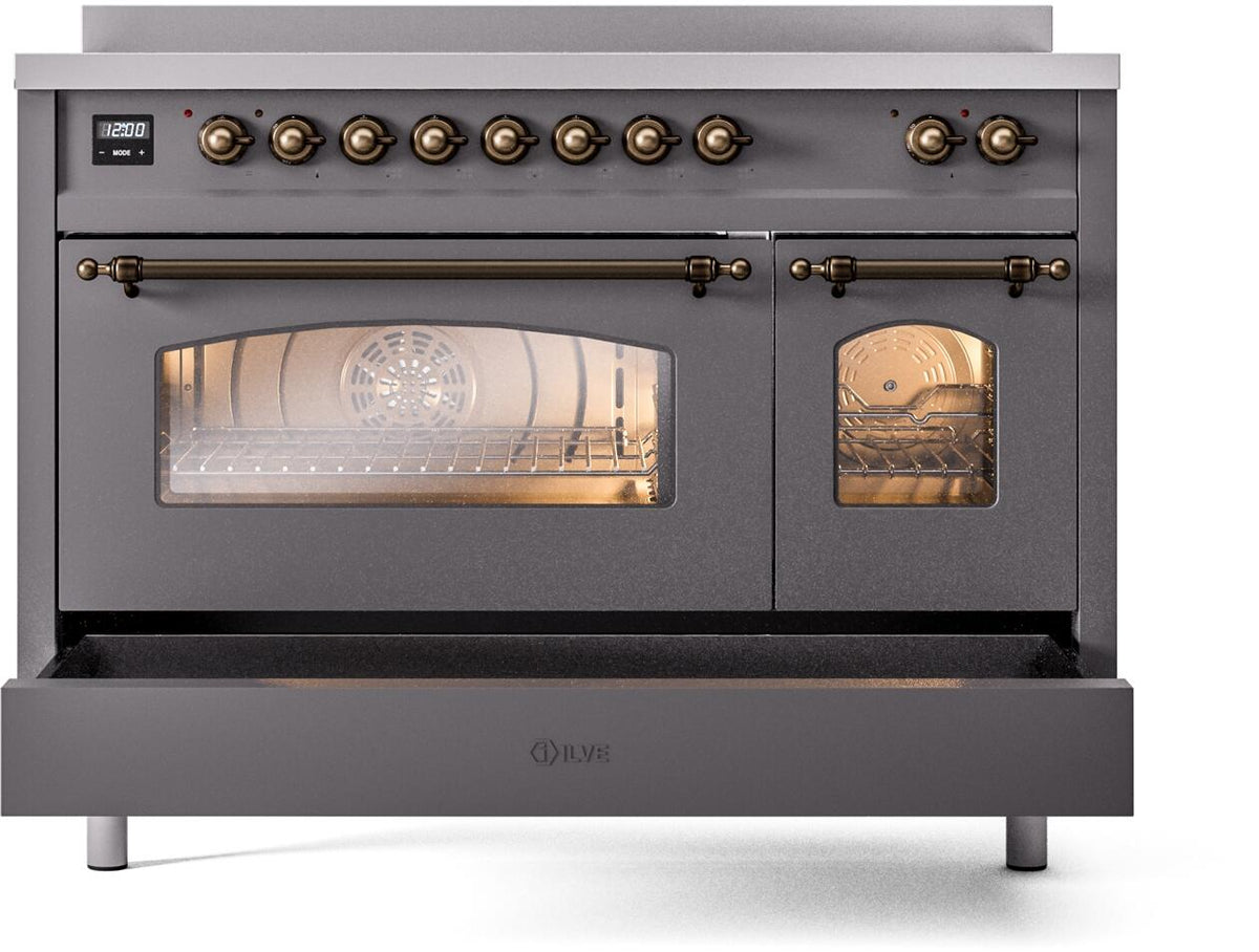 Matte graphite range front with bronze knobs and oven window with lit interior