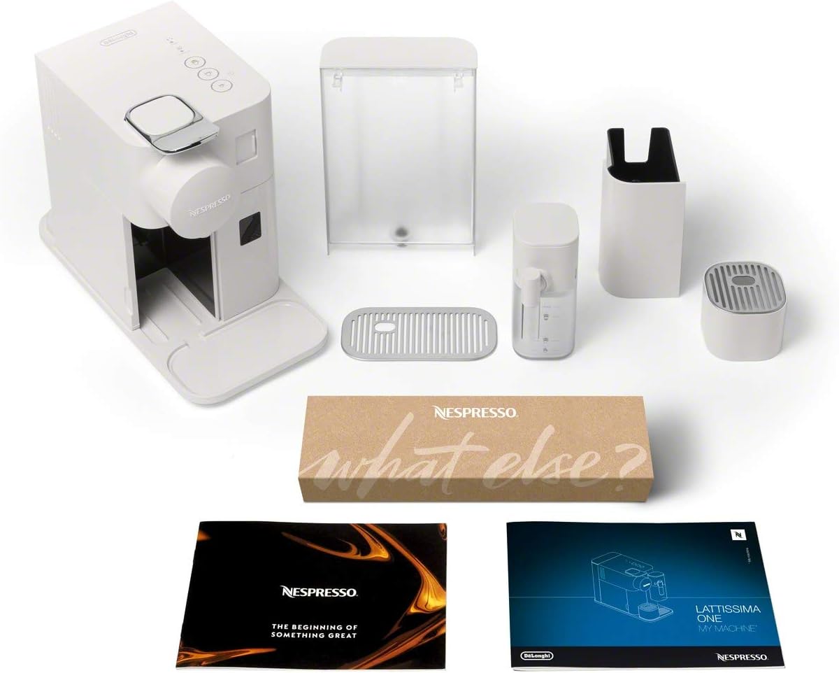 White coffee machine with detachable parts and accessories laid out on display