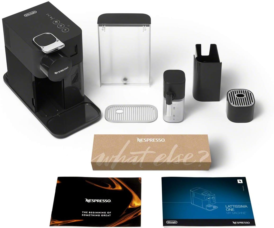 Black Nespresso single-serve espresso machine with accessories and drip tray included