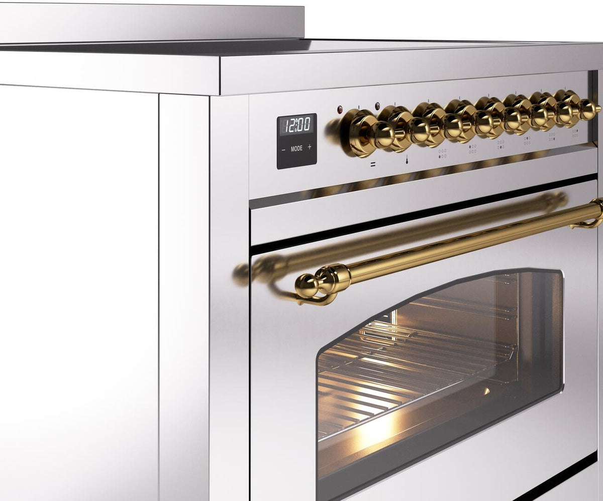 Brass control knobs and handle on a stainless induction range with open oven