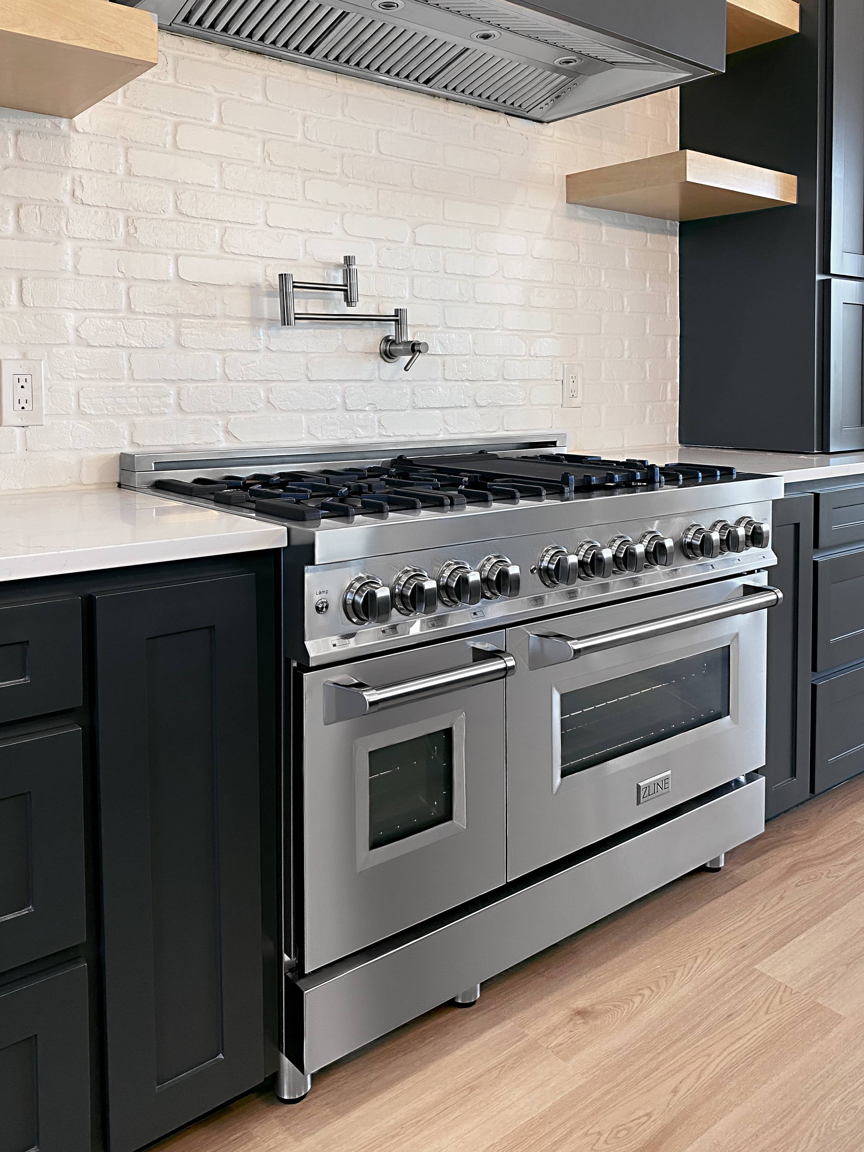 Stainless steel dual-fuel range with burners, knob row, and oven window