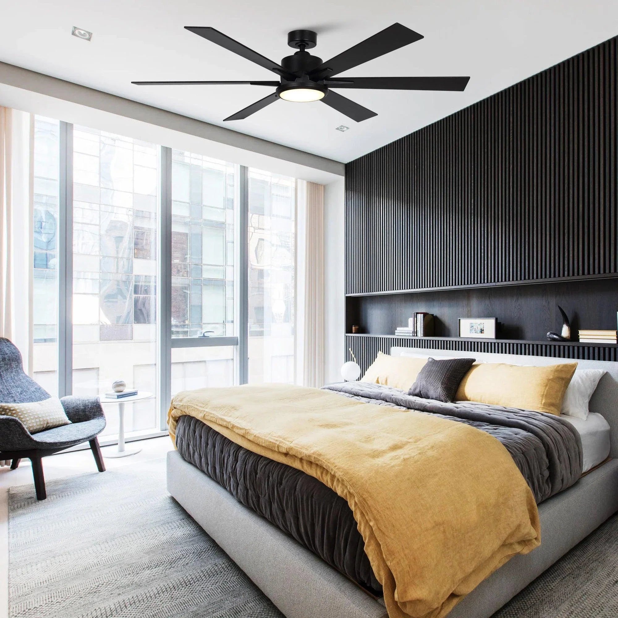 Black ceiling fan with five blades and lit light fixture in modern room