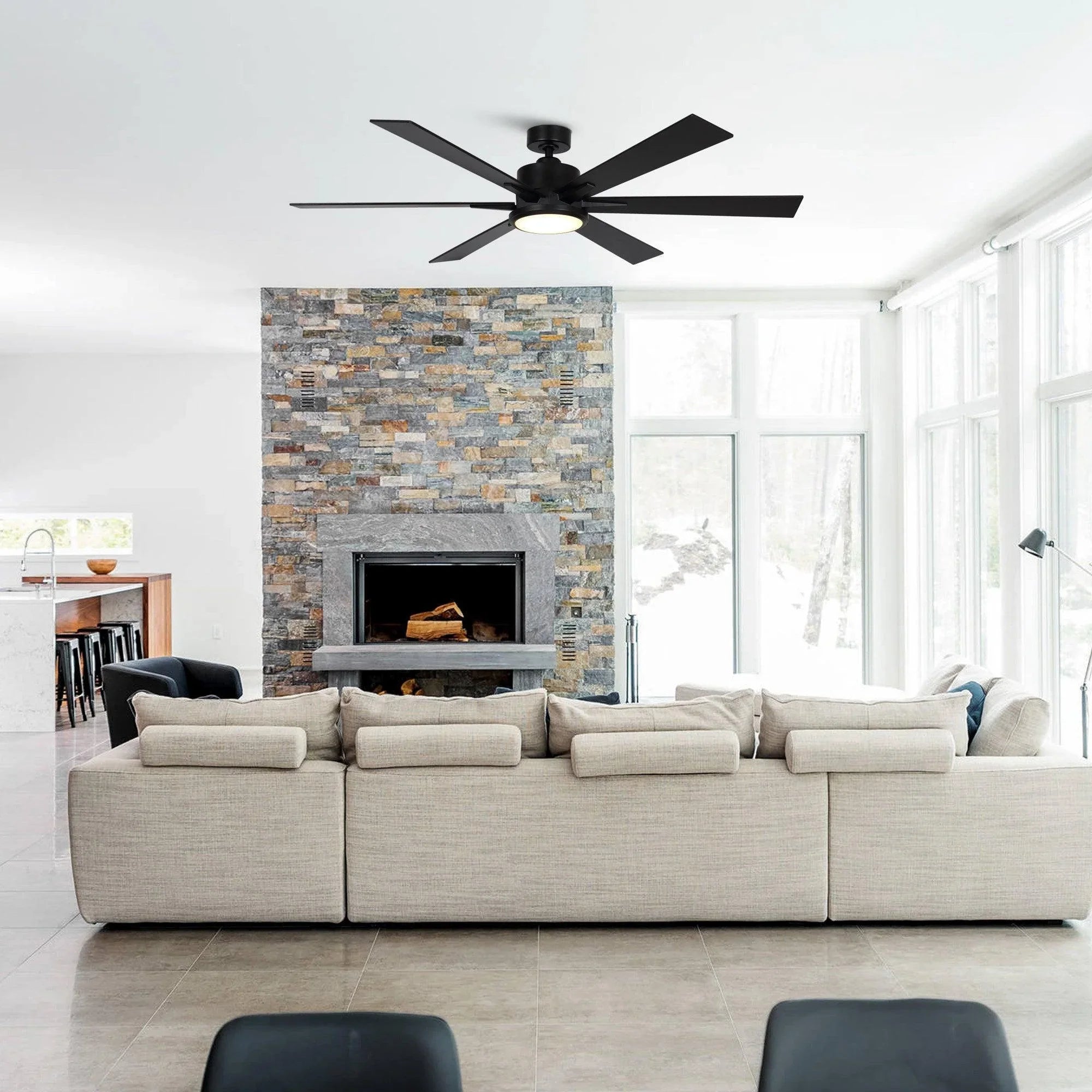 Black ceiling fan with five blades installed over living room seating