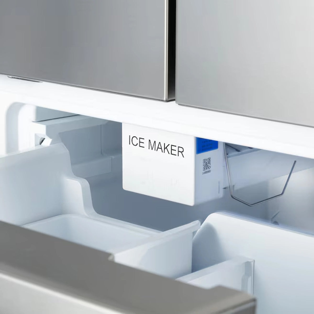 Refrigerator ice maker compartment with white bin and front access panel