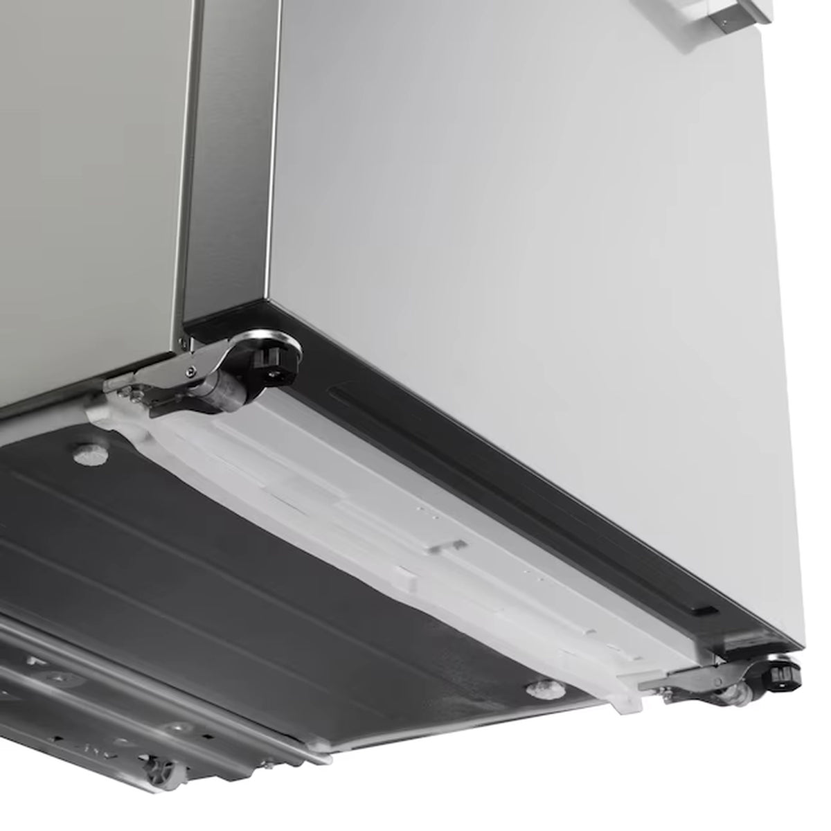 Stainless steel French door refrigerator with open freezer drawer and white ice bin