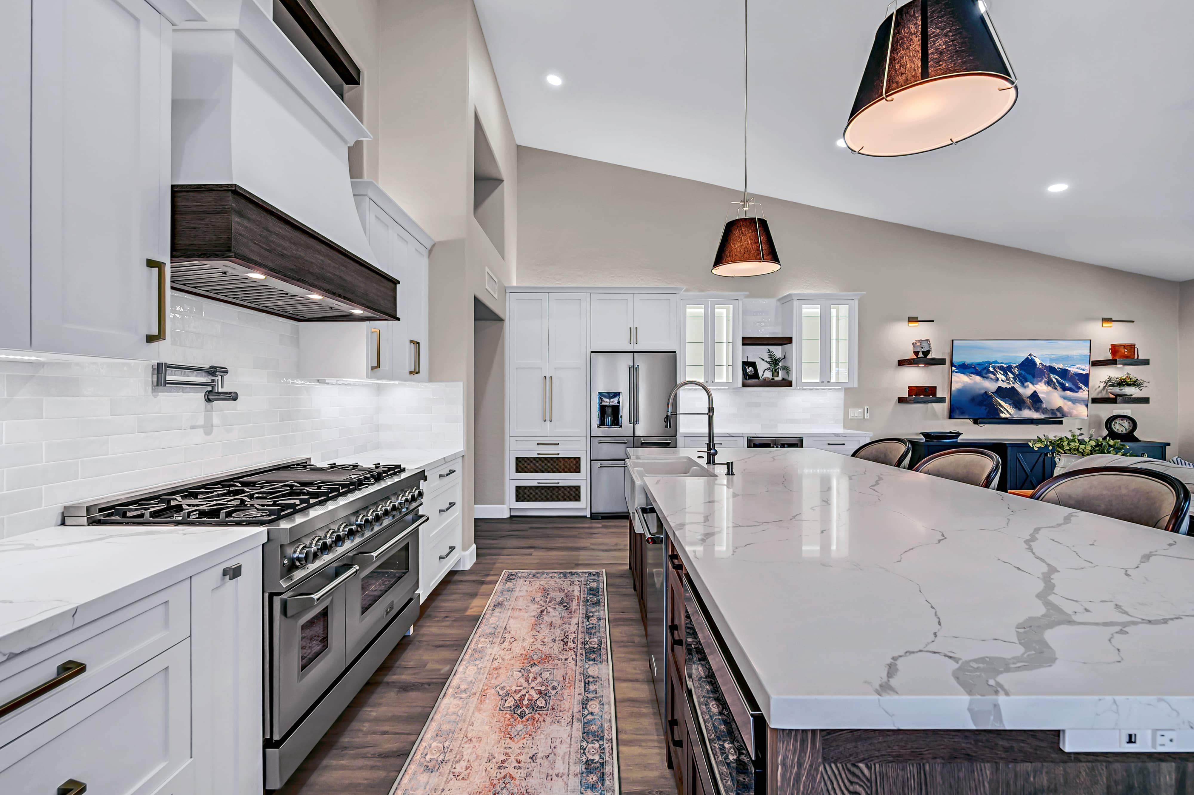 Stainless steel dual-fuel range with vent hood and black burner cooktop